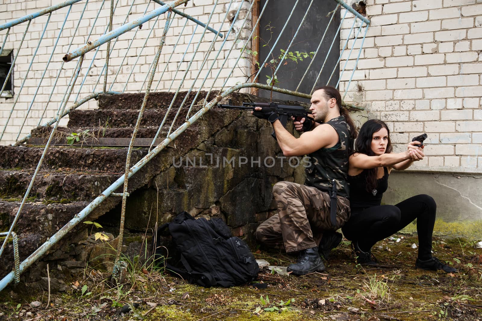 War, conflict. Guy with girl on a battlefield