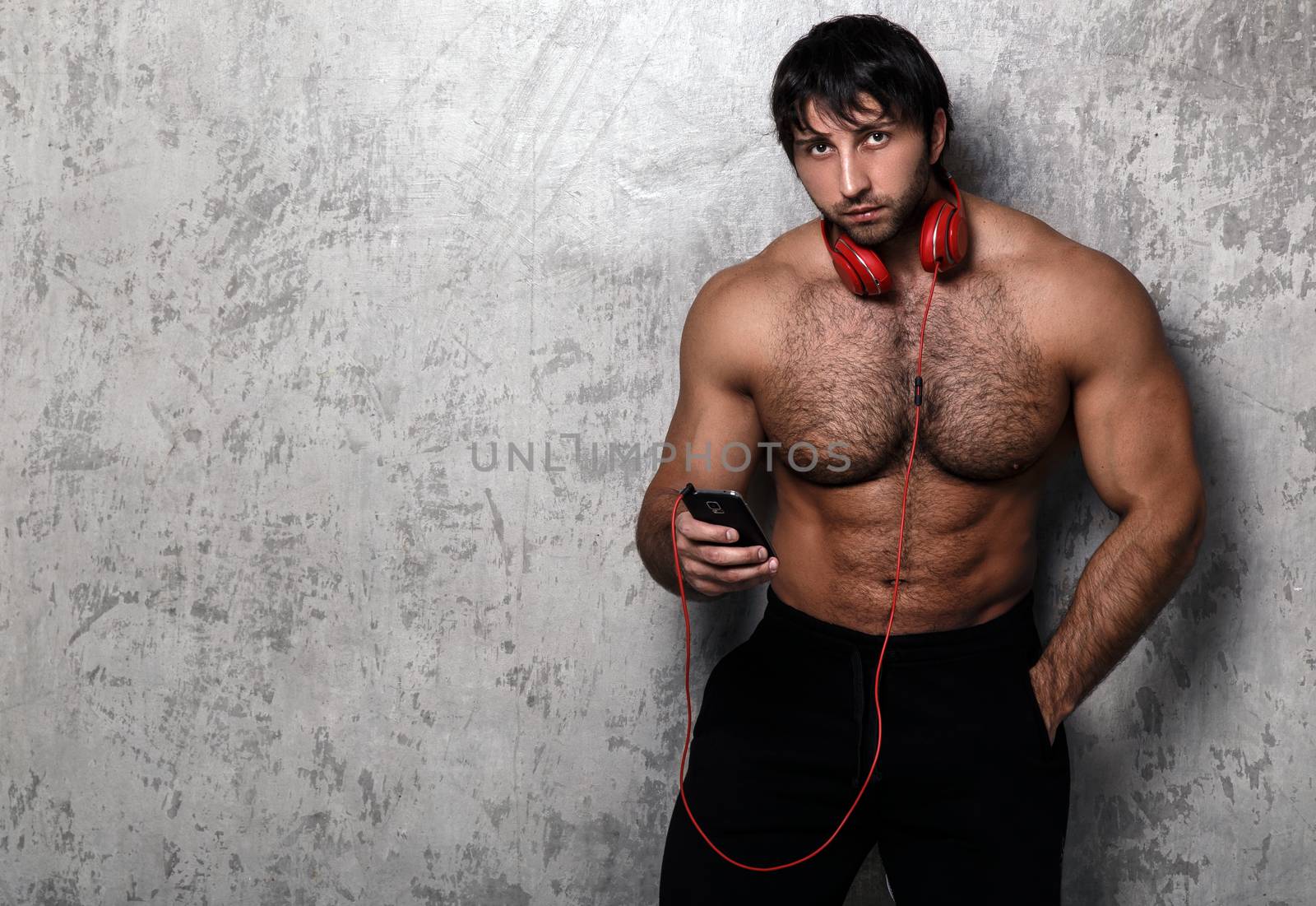 Bodybuilder. Man with red headset