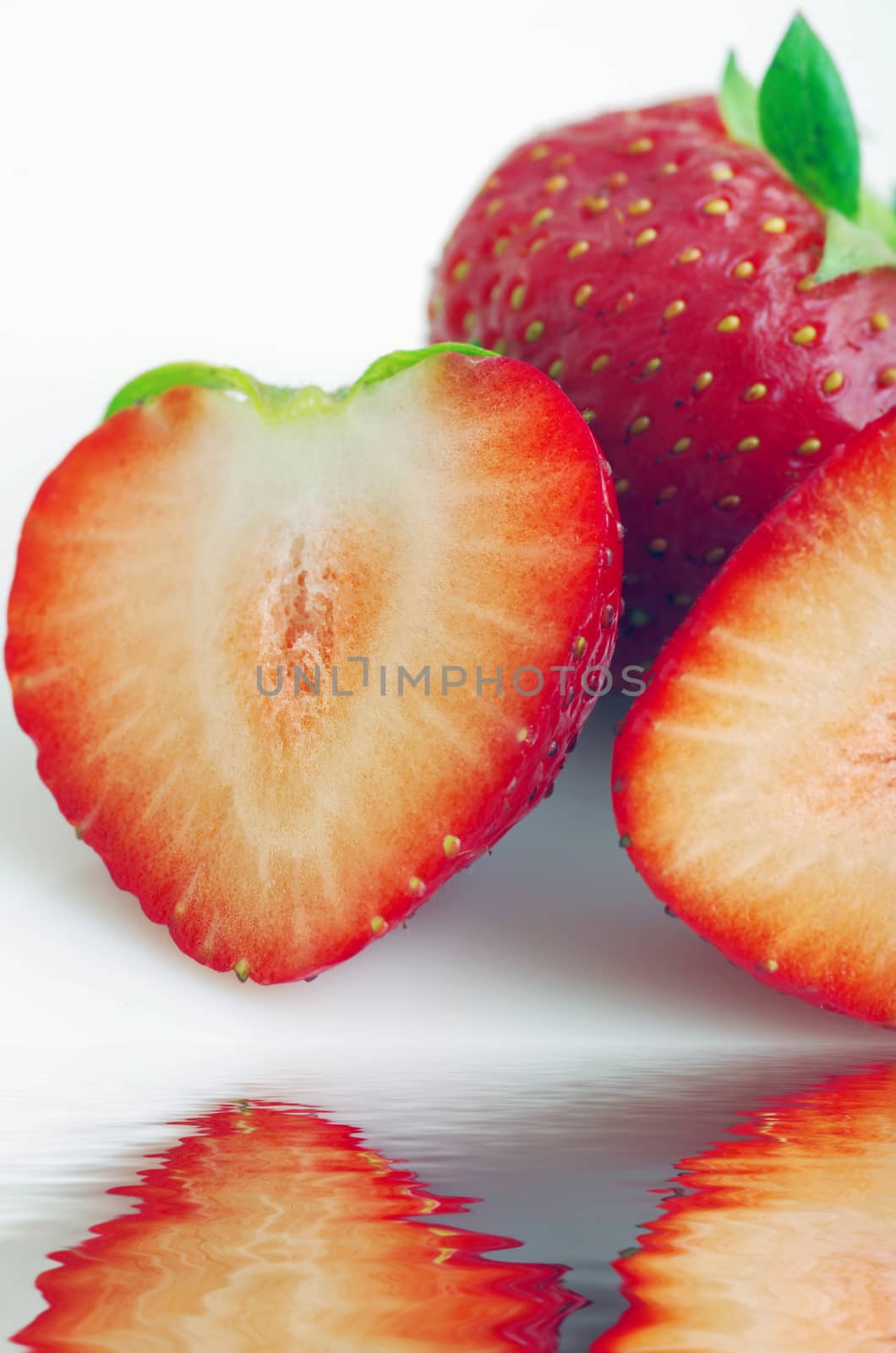 Healthy red strawberry fruit sliced isolated on the white backgr by dolnikow