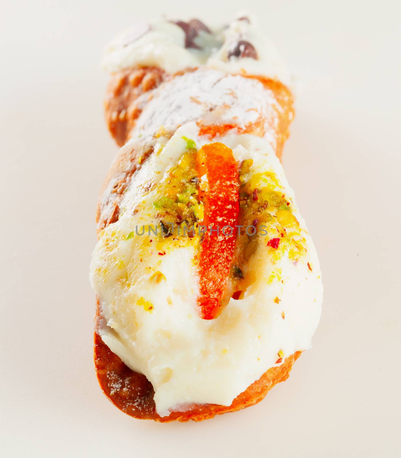 Typical sicilian cannolo, lying over white background