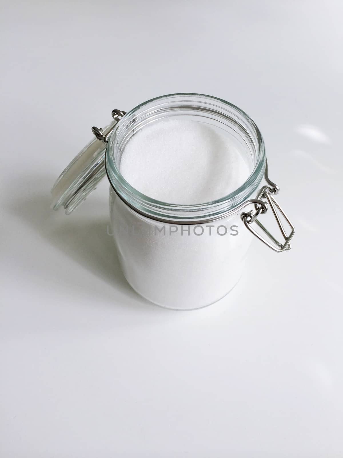 Open jar of refined granulated sugar