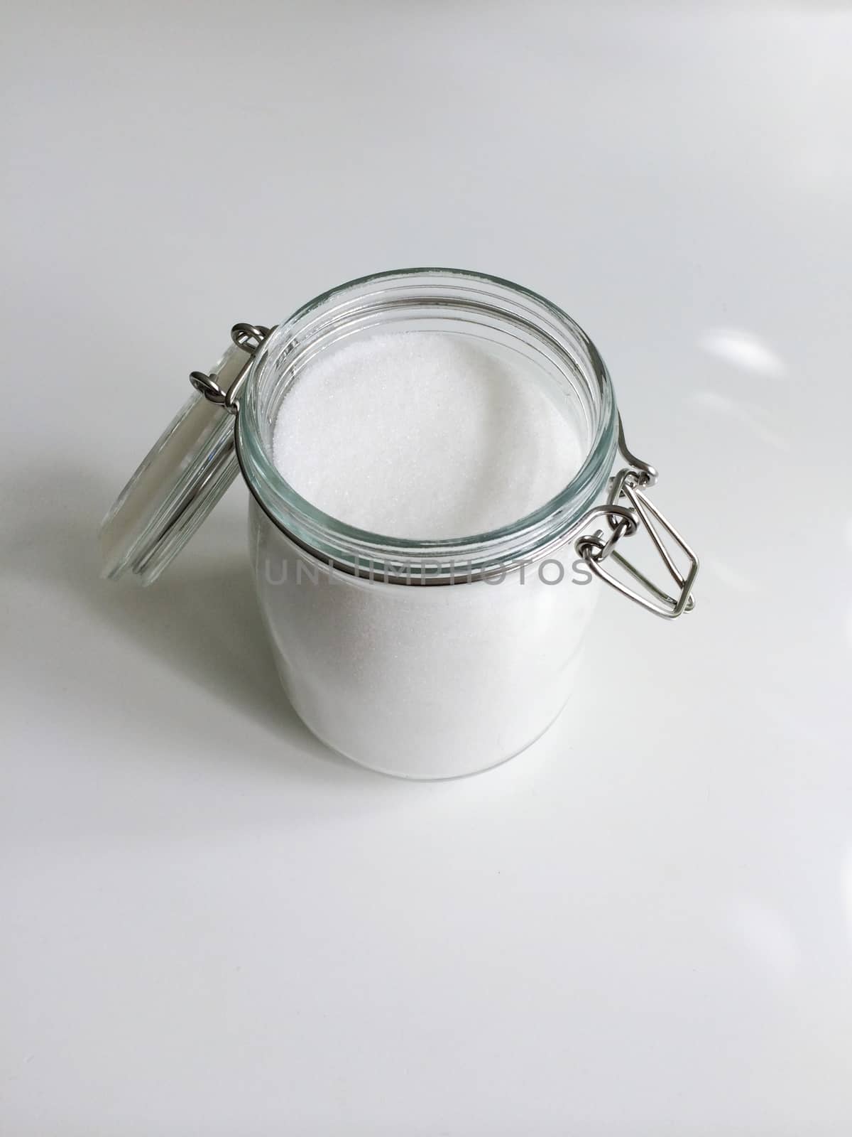 Open jar of refined granulated sugar