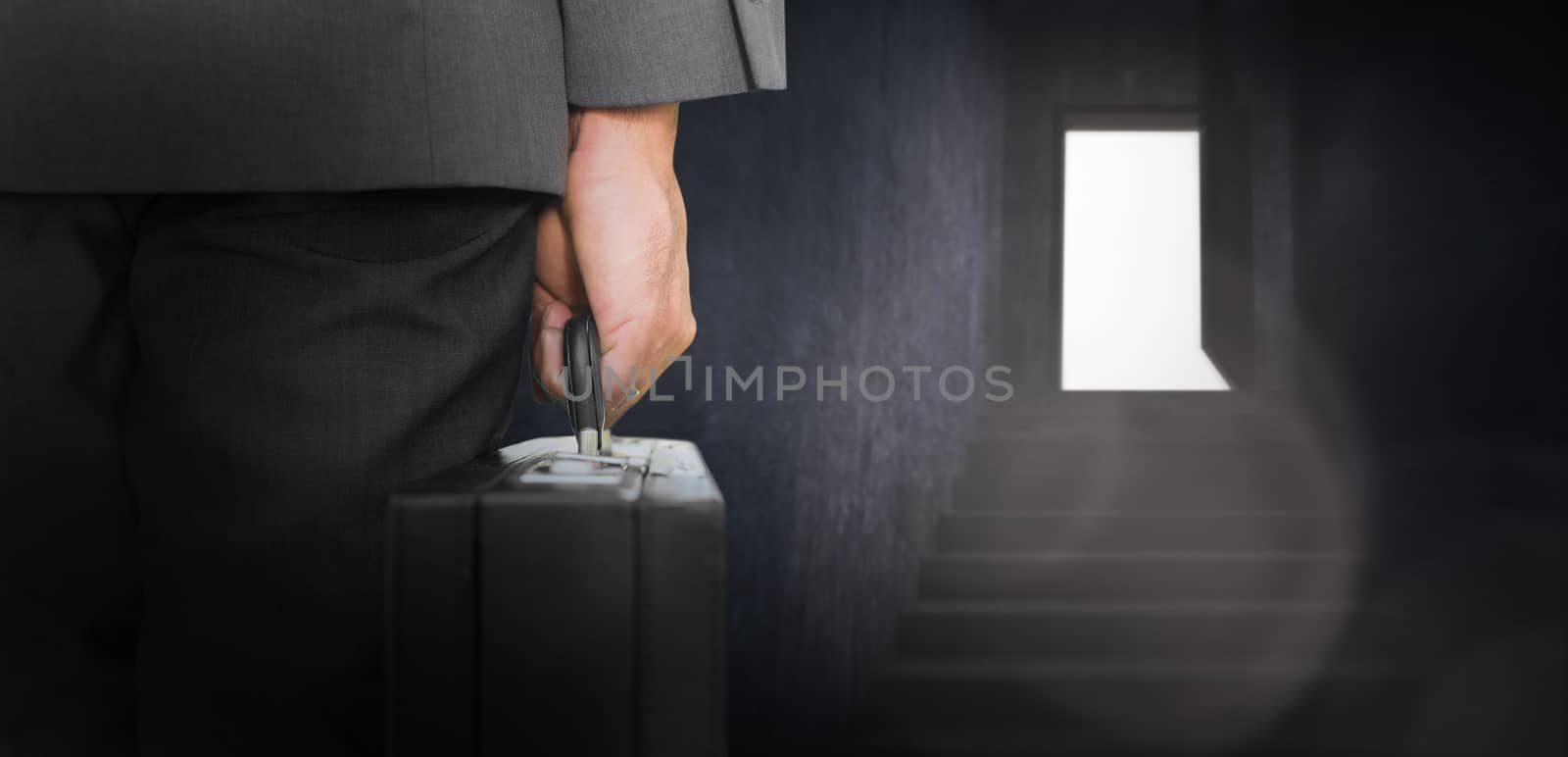 Composite image of businessman holding briefcase by Wavebreakmedia