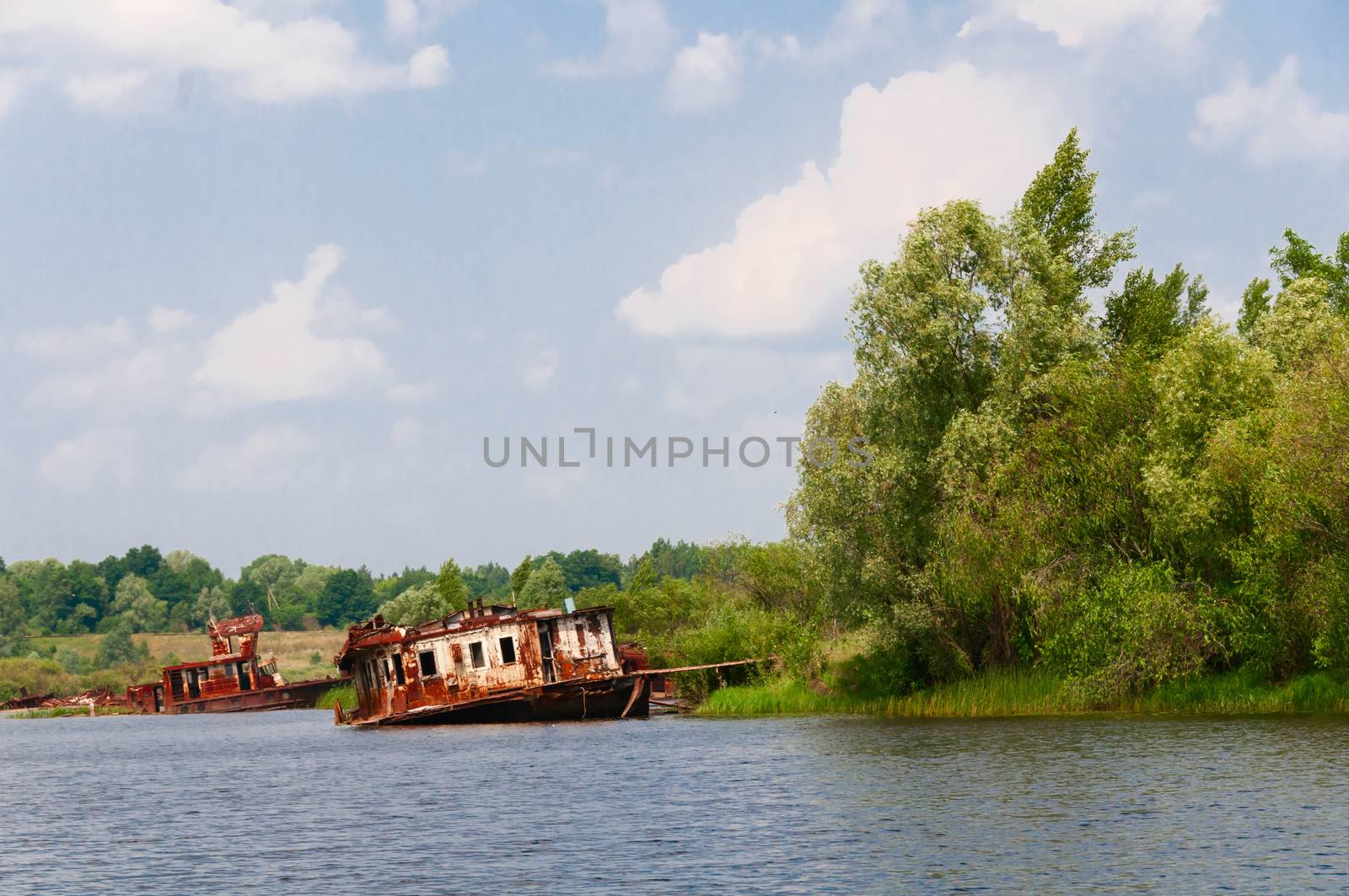 Wrecked abandoned ships on a river after nuclear disaster in Chernobyl, Ukraine
