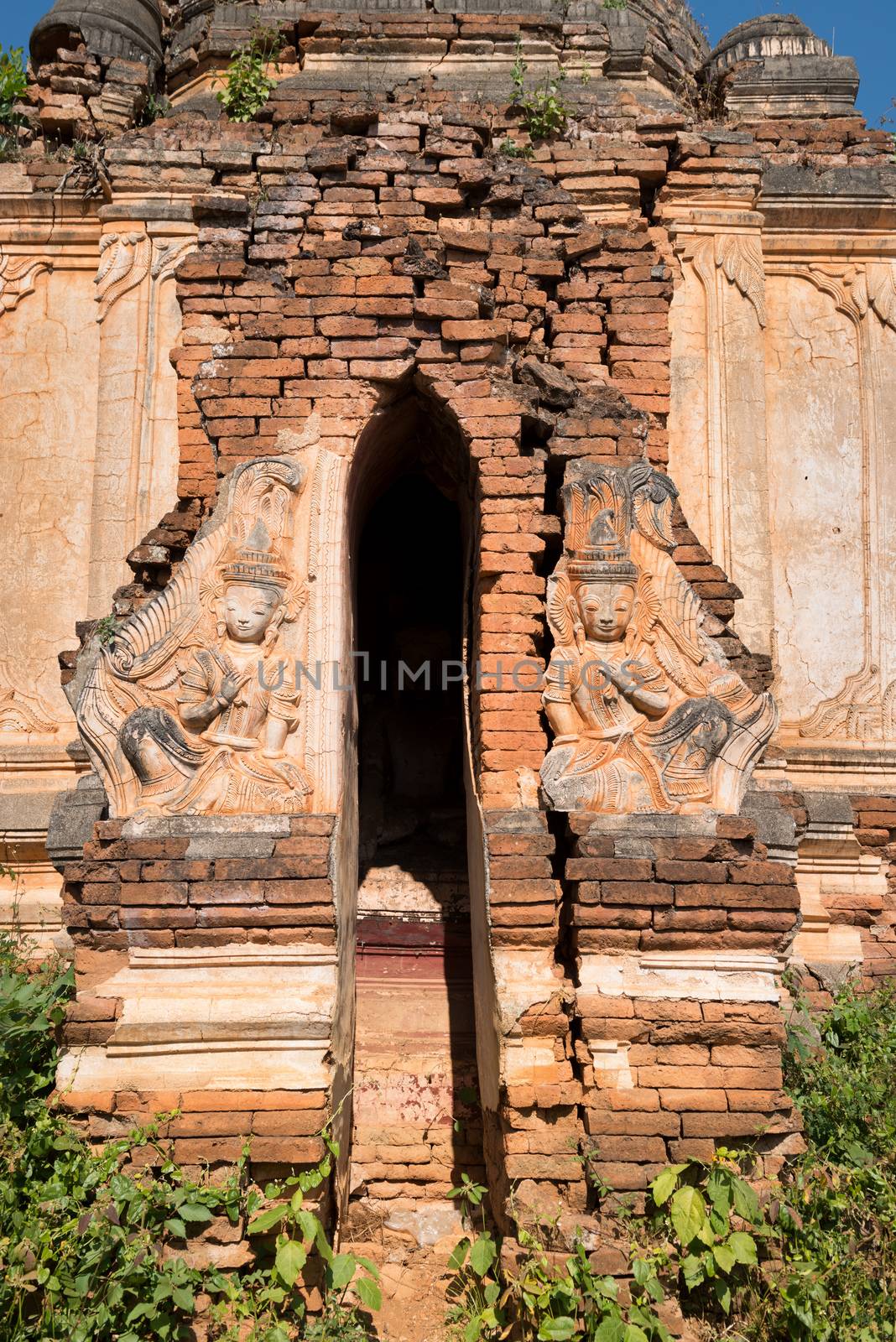 Entrance and  guardians in ruins of ancient Burmese Buddhist pagodas in the village of Indein on Inlay Lake, Myanmar (Burma).