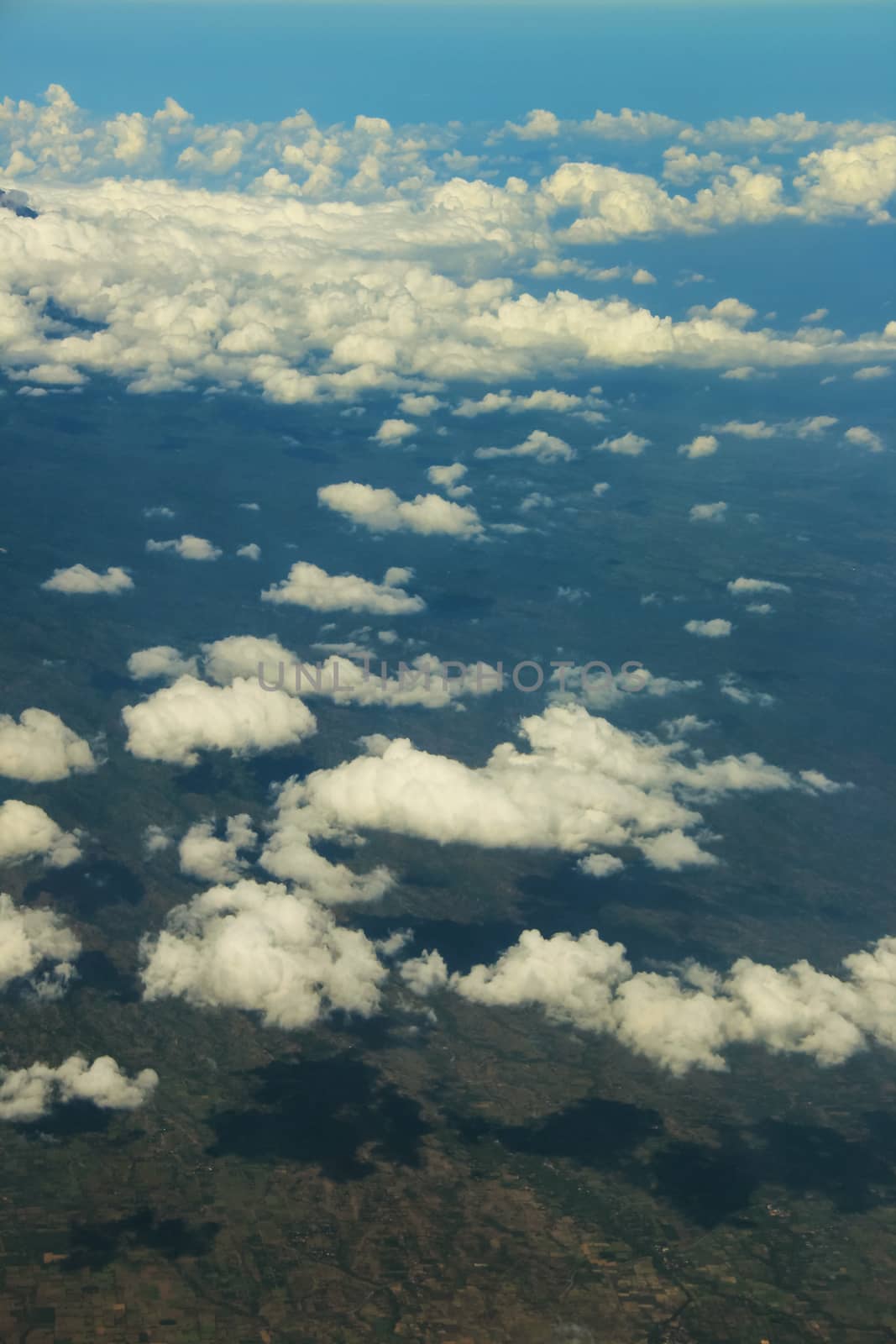 Soft clouds over view from airplane flying