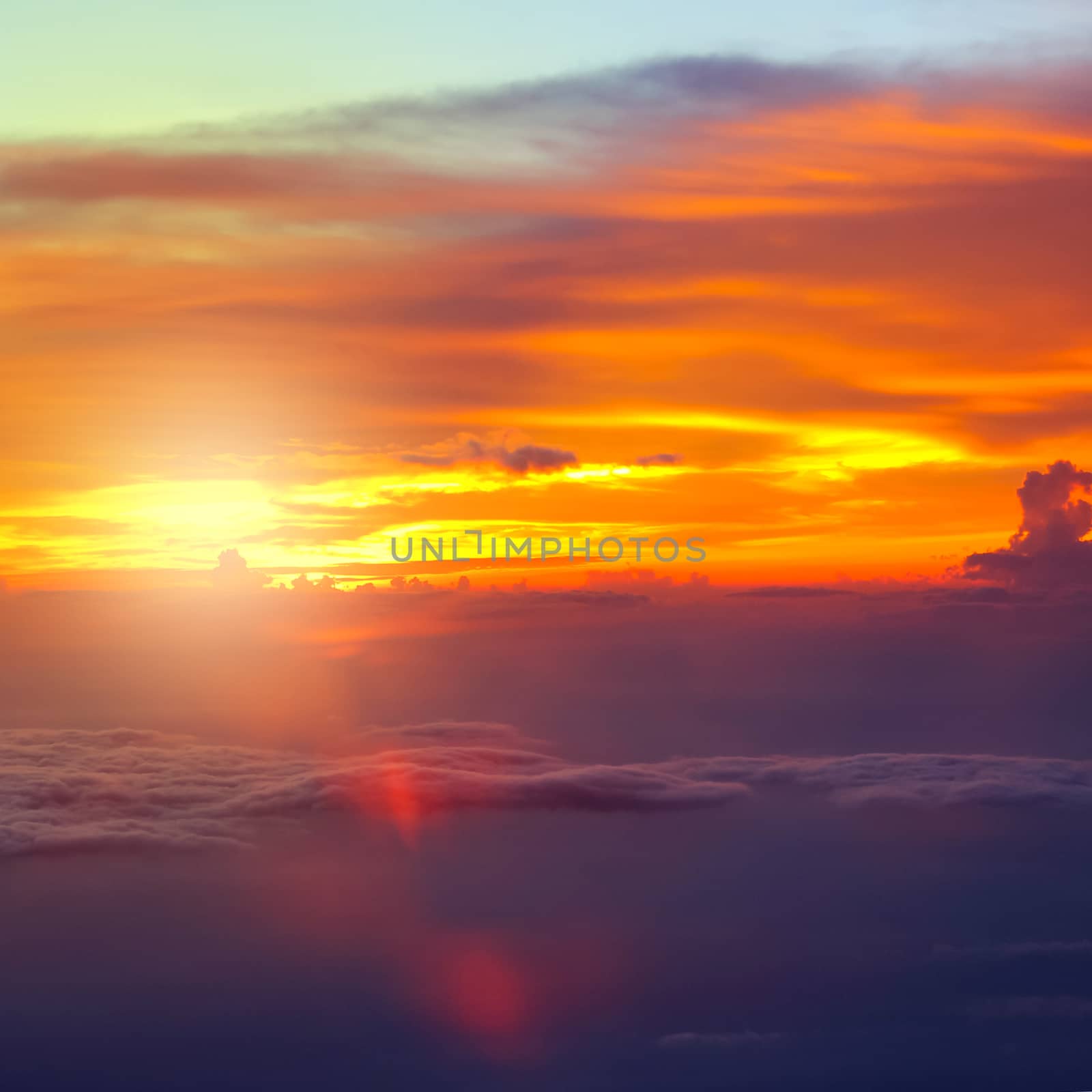 Sunset with clouds over view from airplane flying