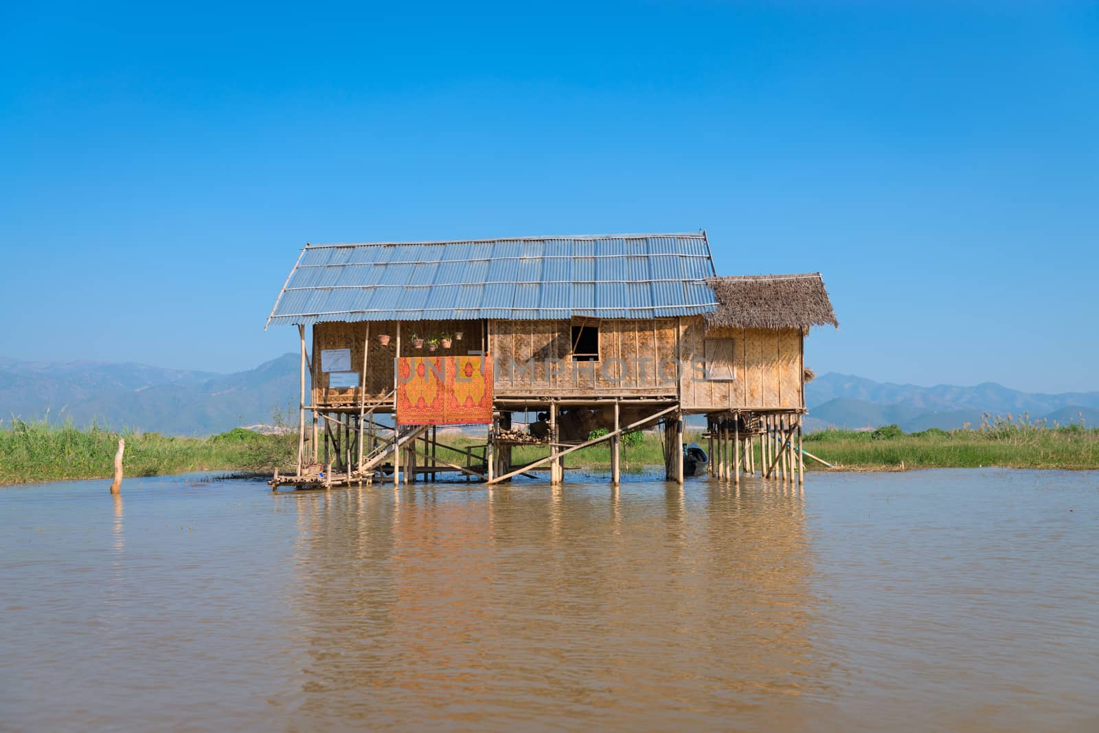 Traditional stilts wooden and bamboo house of Intha people in water on Inle lake, Myanmar (Burma) 
