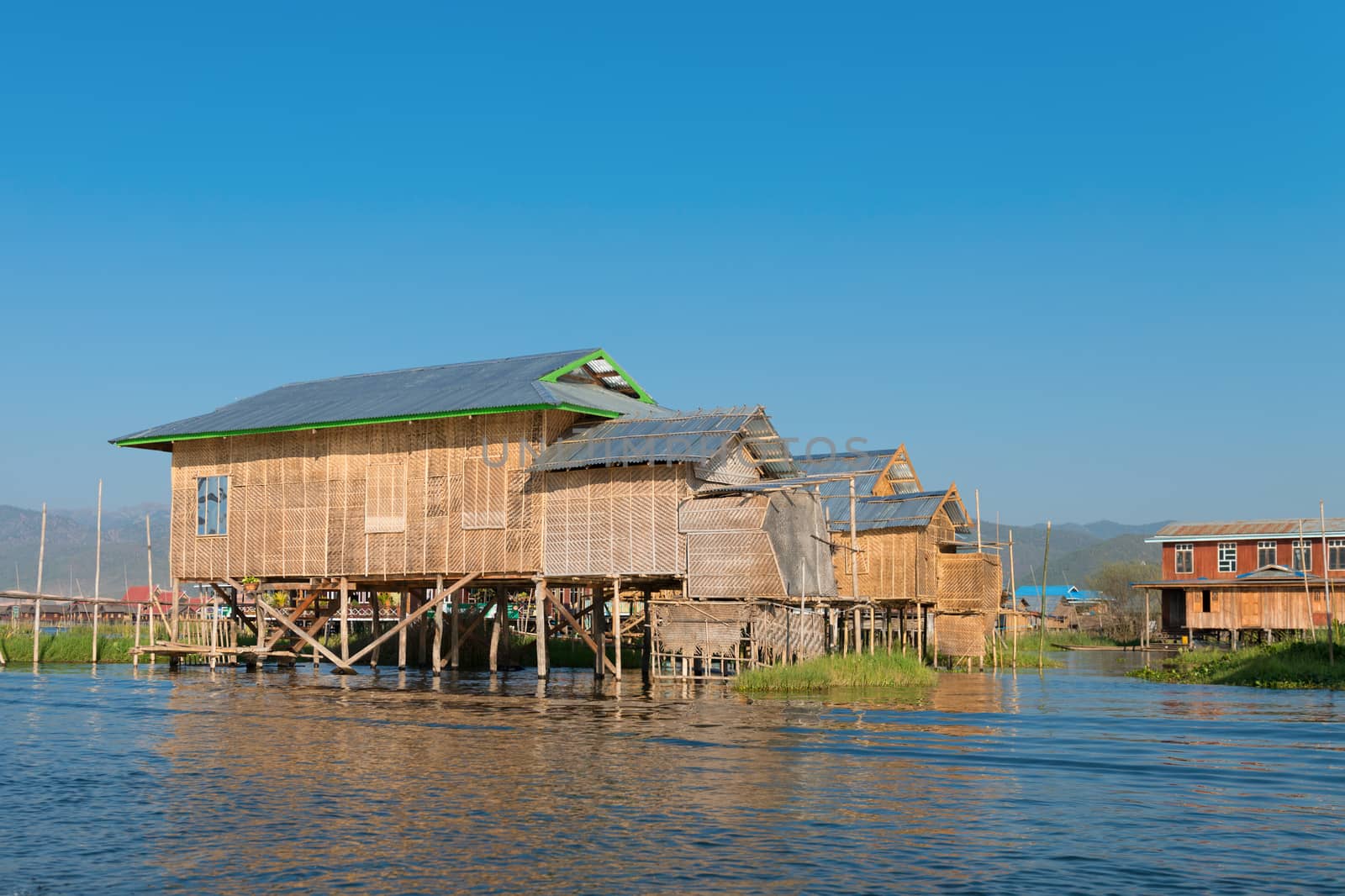 Traditional stilts wooden and bamboo houses of Intha people in water on Inle lake, Myanmar (Burma) 