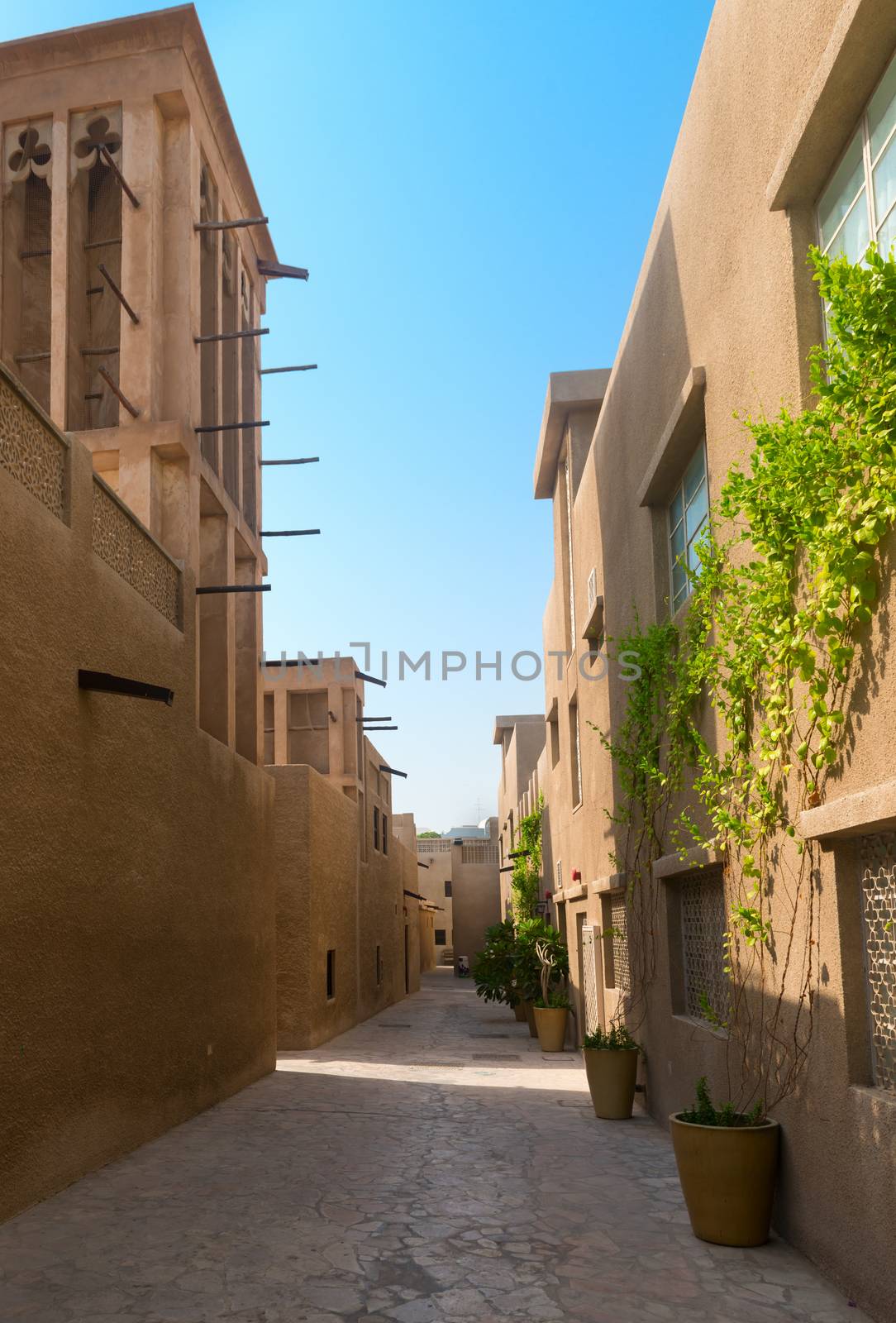 Tiny alleyways and wind towers in the old merchant quarter of Bastakiya in Dubai, United Arab Emirates. .