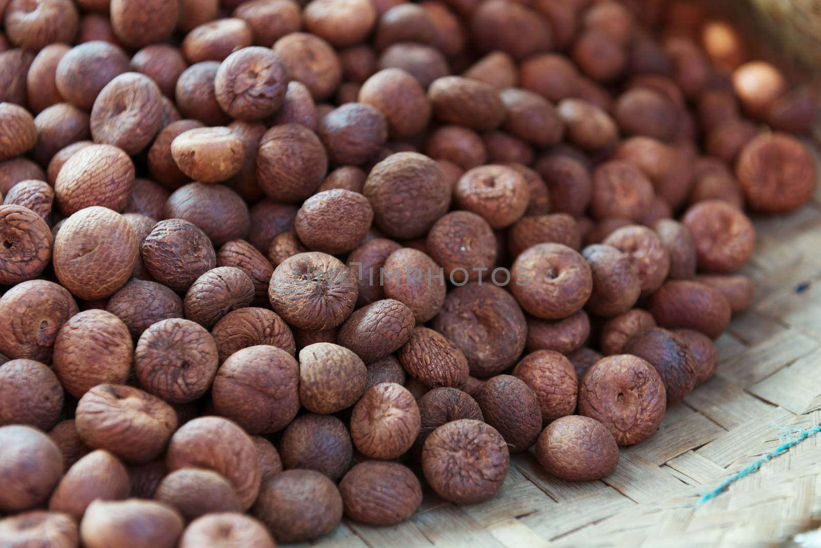 Heap of dry full nutmegs on open market