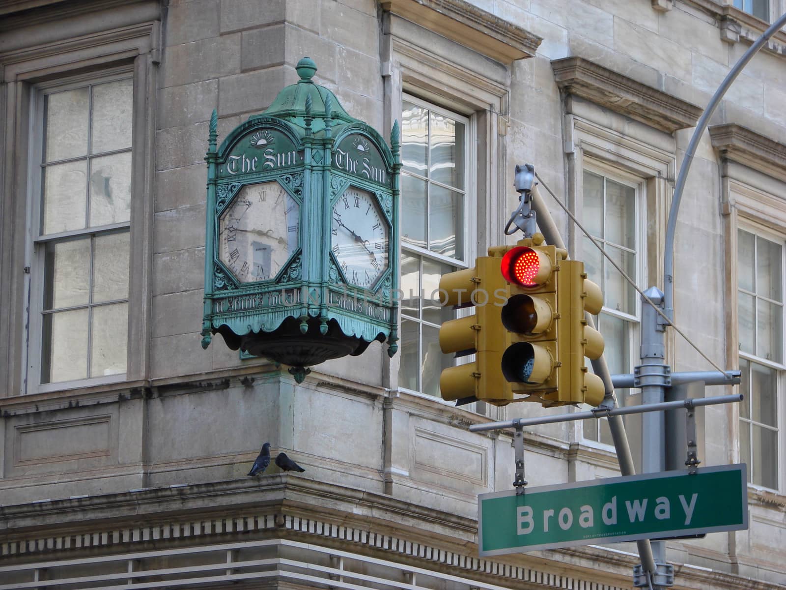 Broadway clock and red sign on the traffic light                               