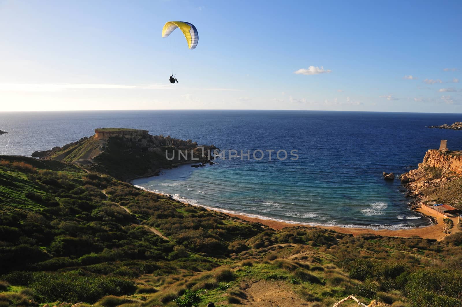 Paraglider over maltese beach and mediterranean sea