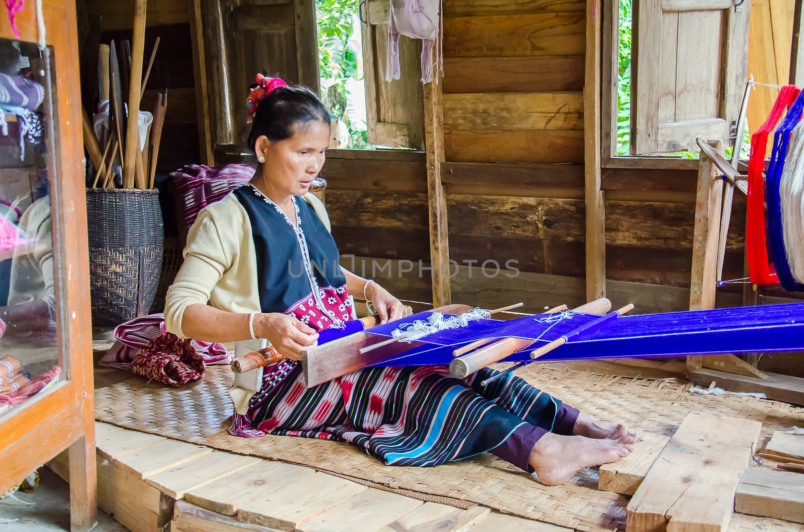 Women Pa-Ka-Geh-Yor (Karen Sgaw) in Tribal dress was weaving. Ethnic group spread north of Thailand. Image is taken at Doi Inthanon, Chiang Mai,Thailand.