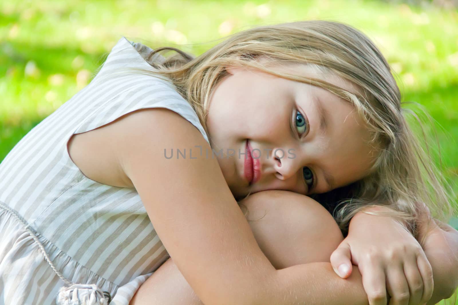 Cute girl with blond long hair and blue eyes