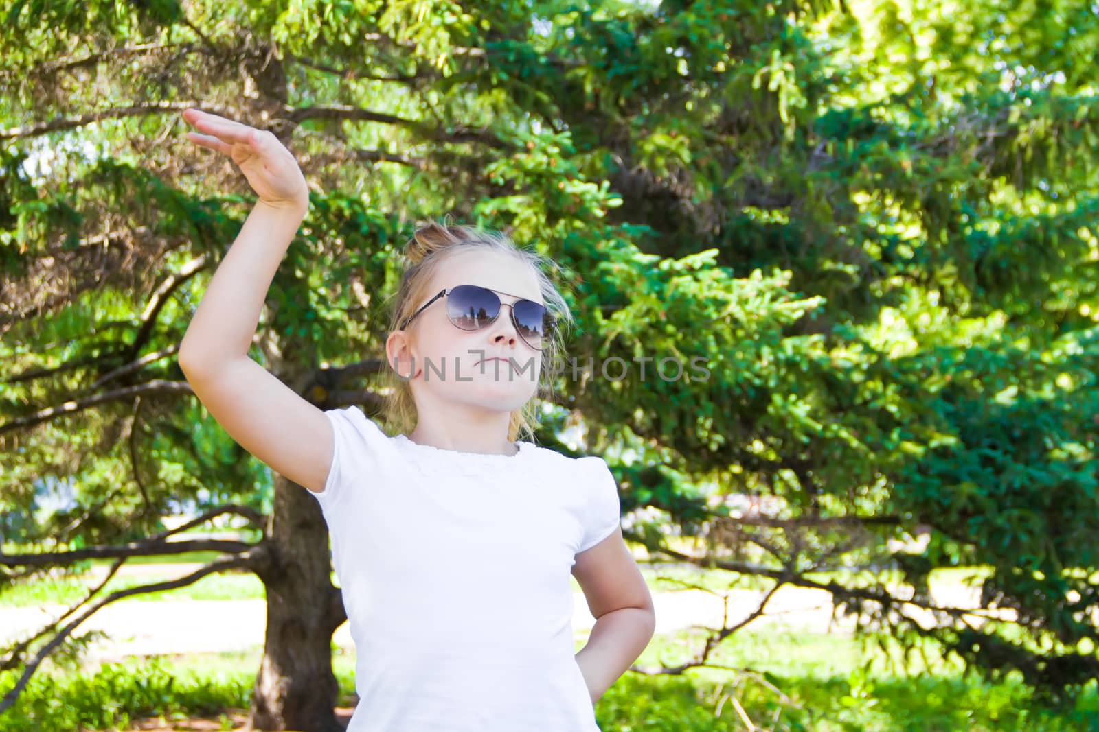 Photo of cute dancing girl with sunglass in summer
