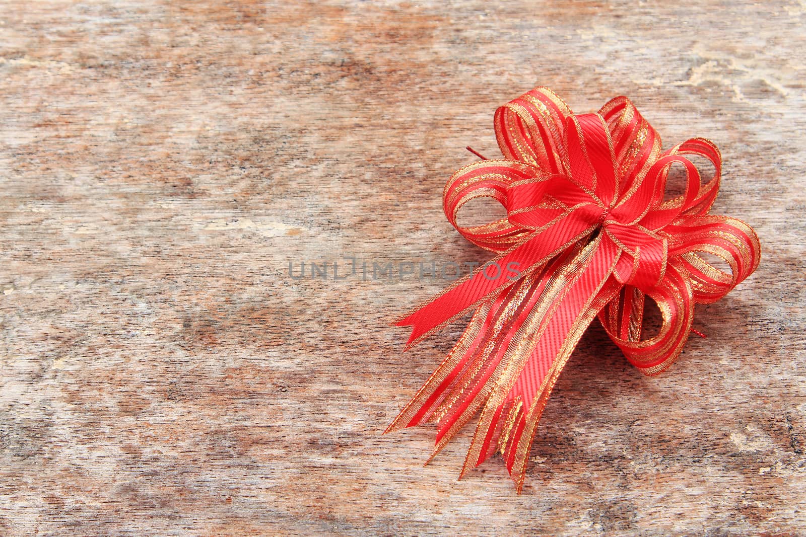 Red Ribbon on Old Wood Background by foto76