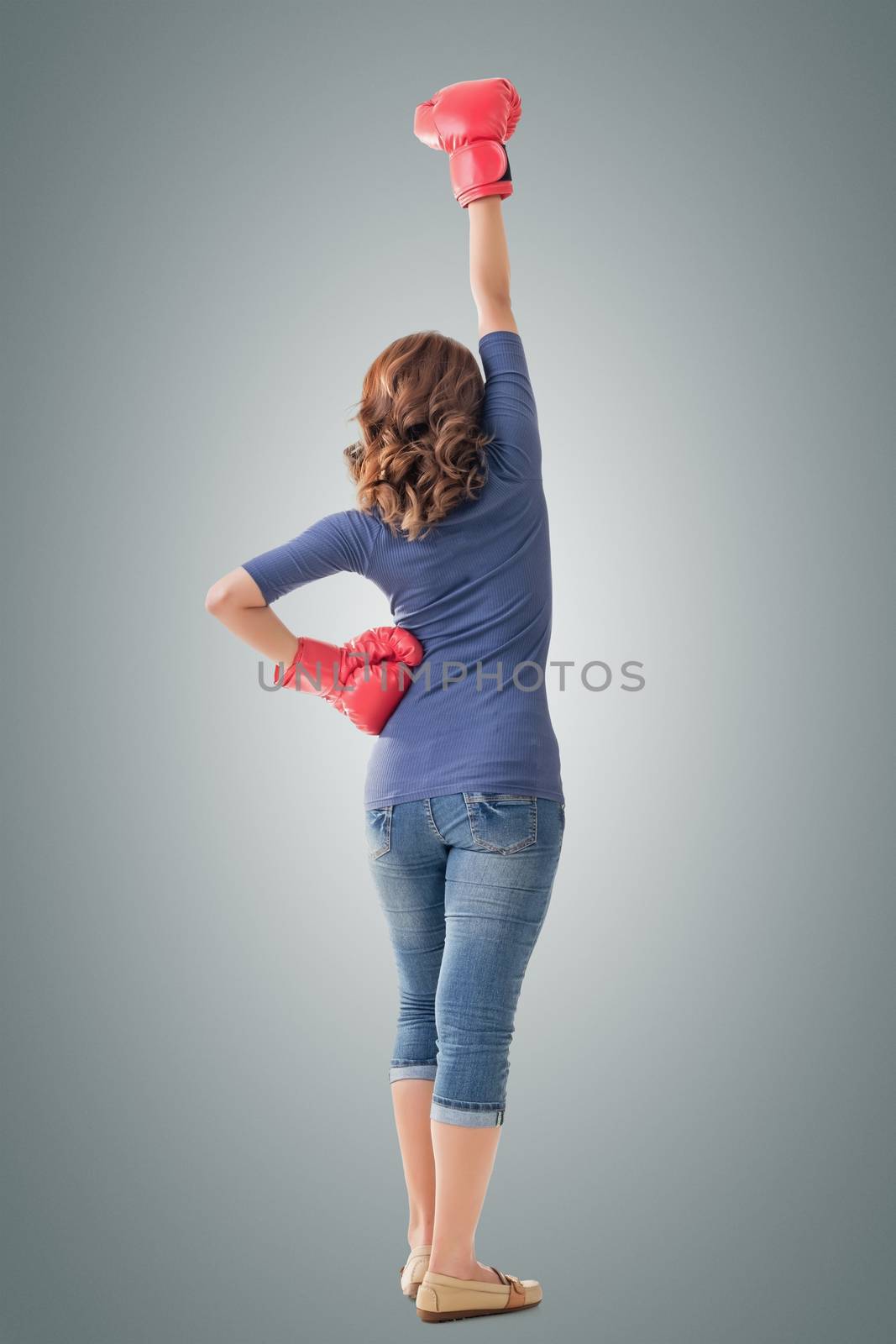 Fighting girl concept, rear view full length portrait of Asian isolated on white.