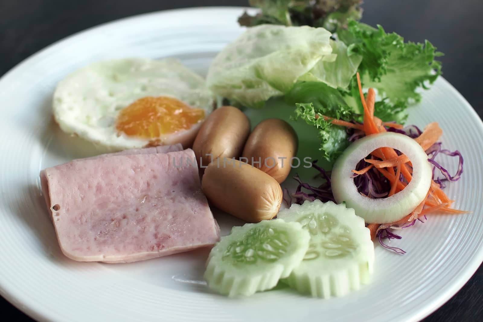 Breakfast meal with ham sausage egg coffee and orange juice