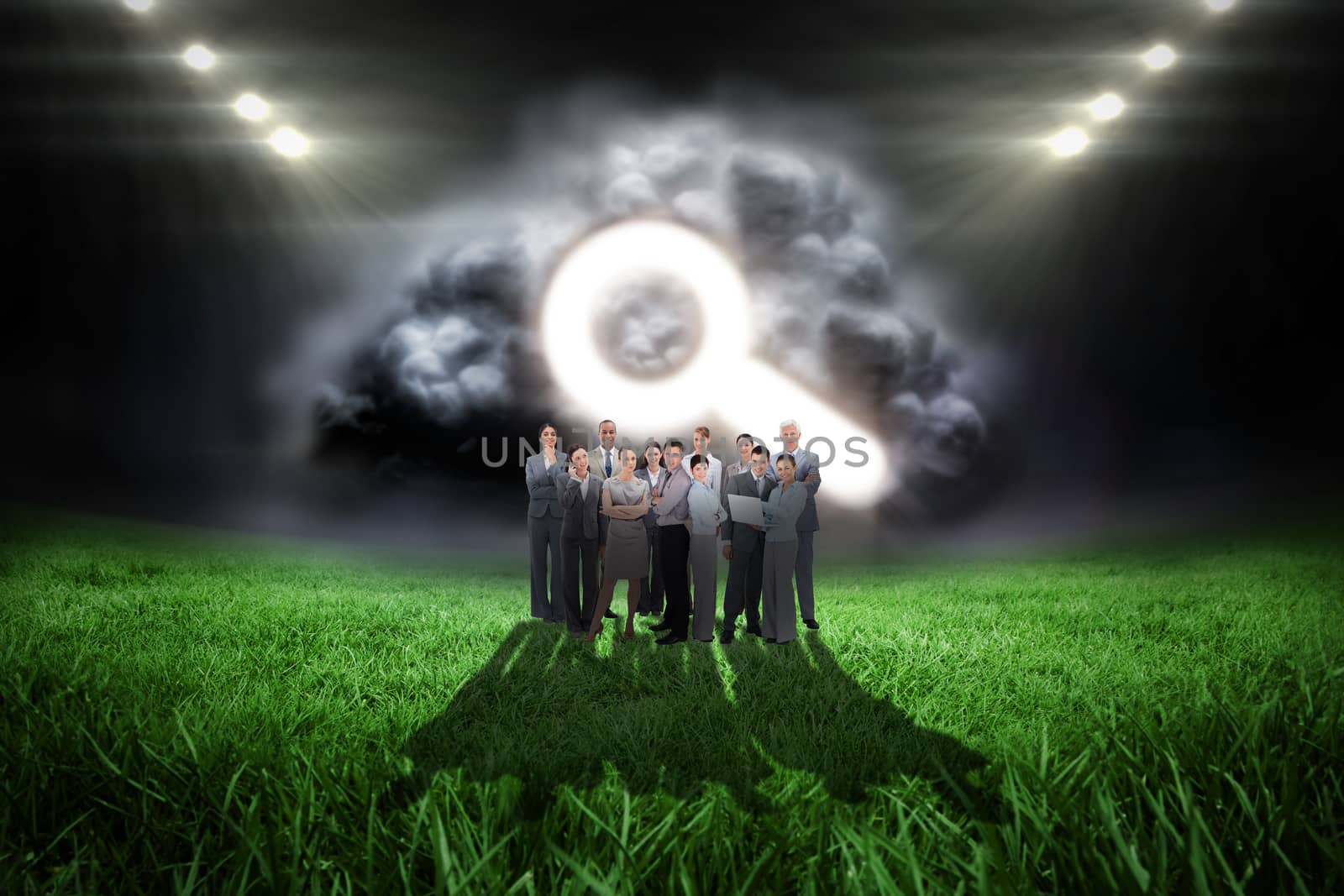 Composite image of business team looking at camera by Wavebreakmedia