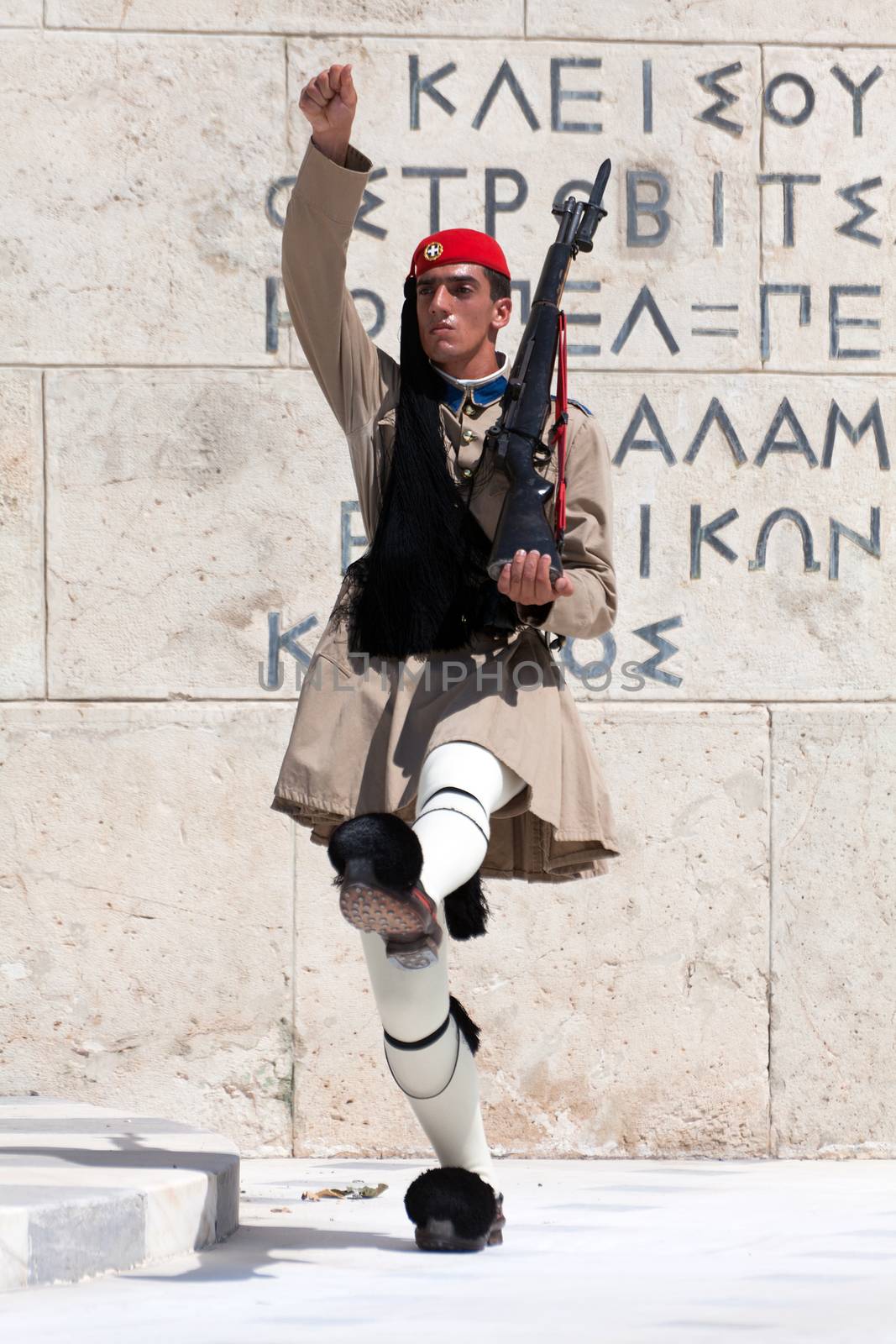 ATHENS, GREECE - JULY 23: Evzones (presidential guards) watches over the monument of the Unknown Soldier in front of the Greek Parliament Building at Syntagma Square on July 23, 2010 in Athens, Greece. Evzoni, is the name of historical elite mountain units of Greek Army.