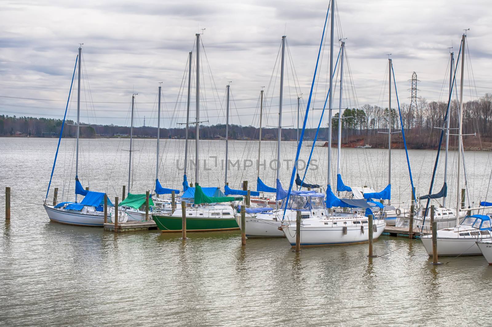 parked yachts in harbour with cloudy skies