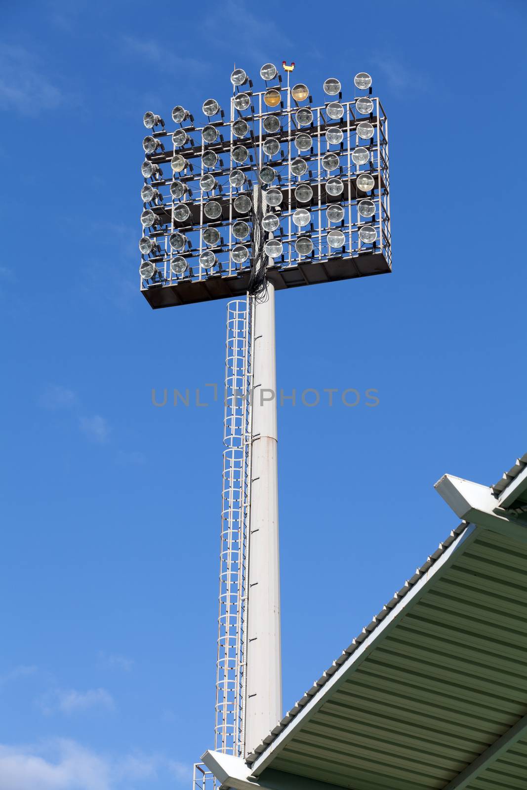 Stadium lights against blue sky background