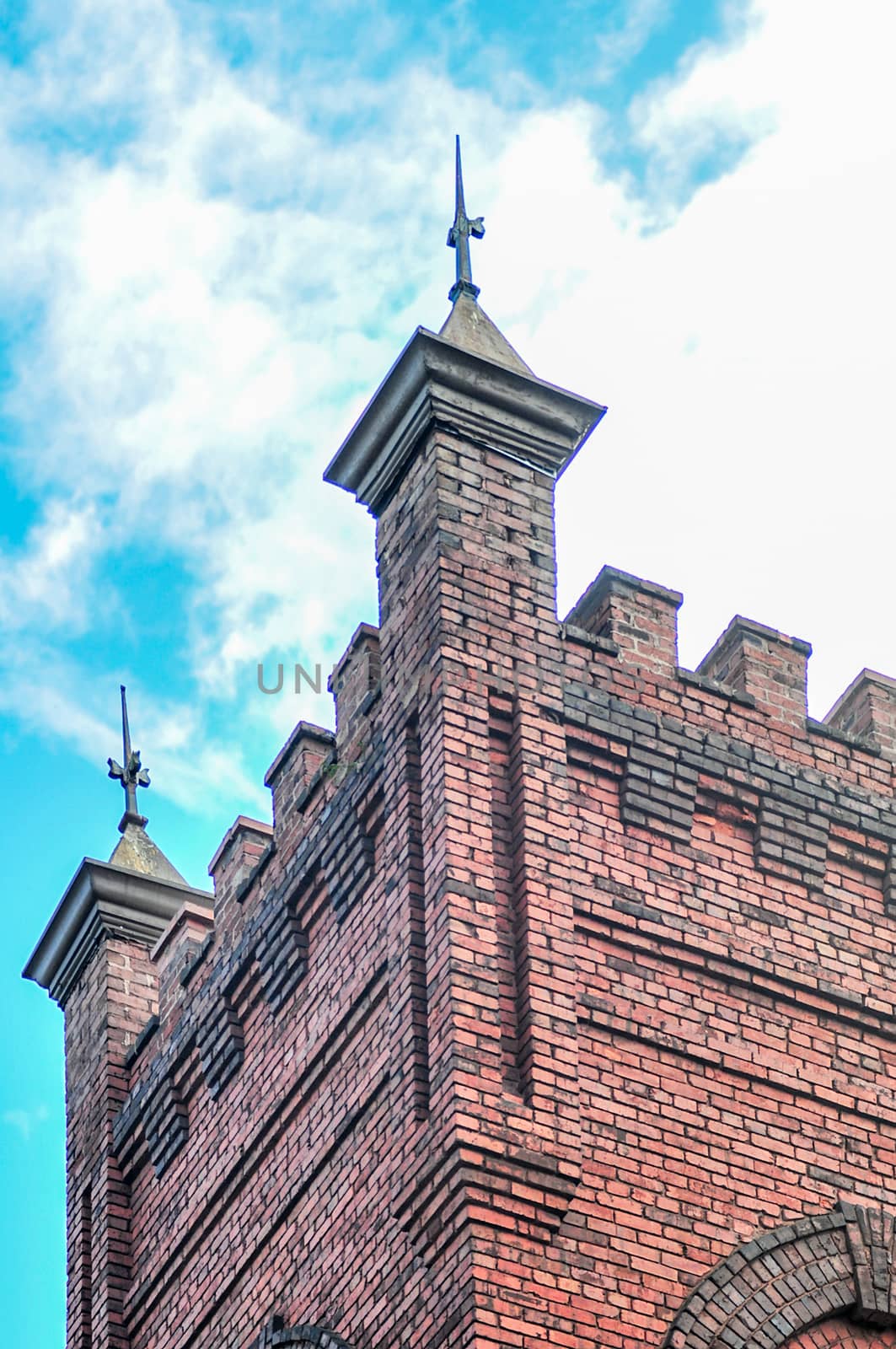 old brick church with blue sky and clouds