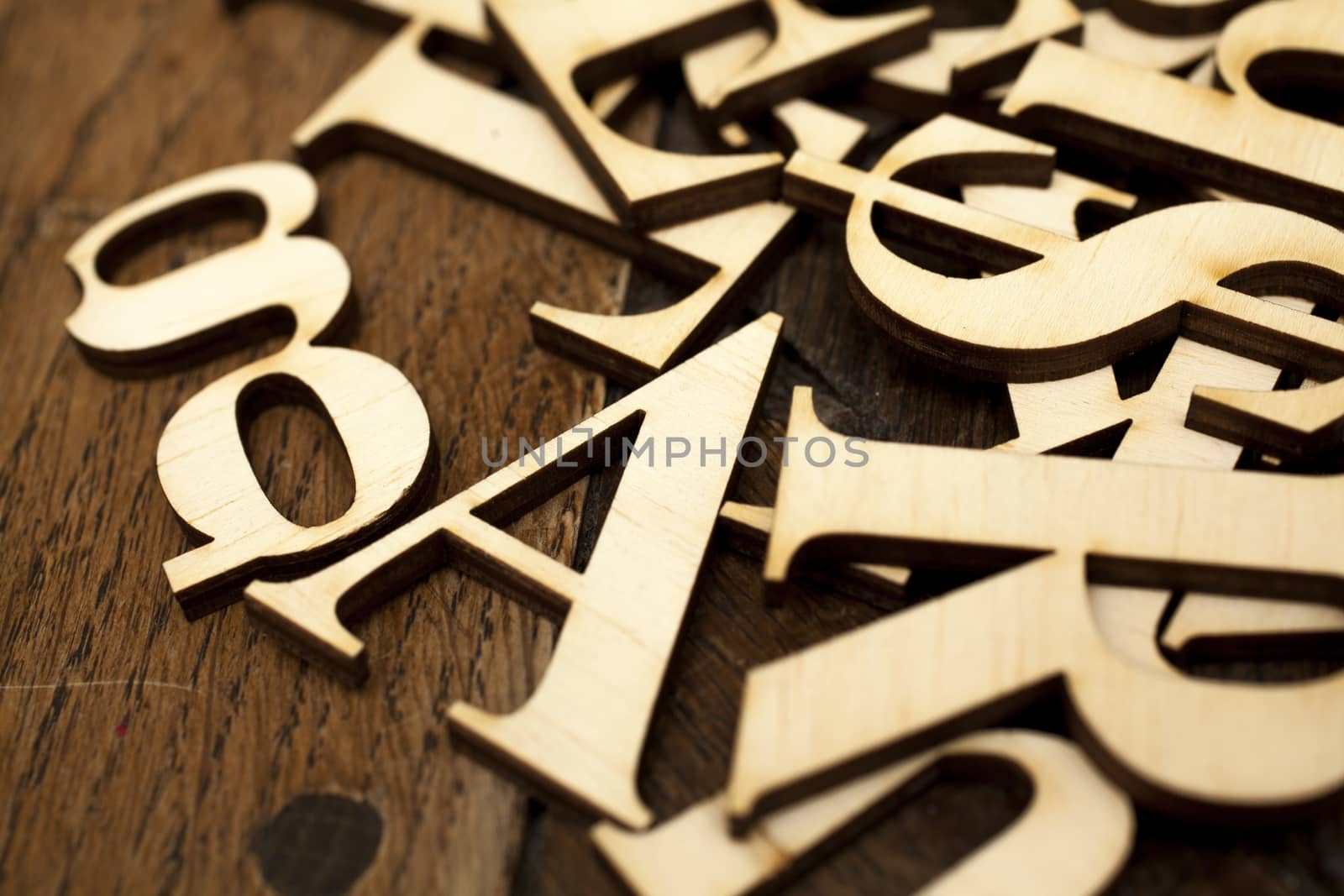 Wooden alphabet letters on old wooden surface