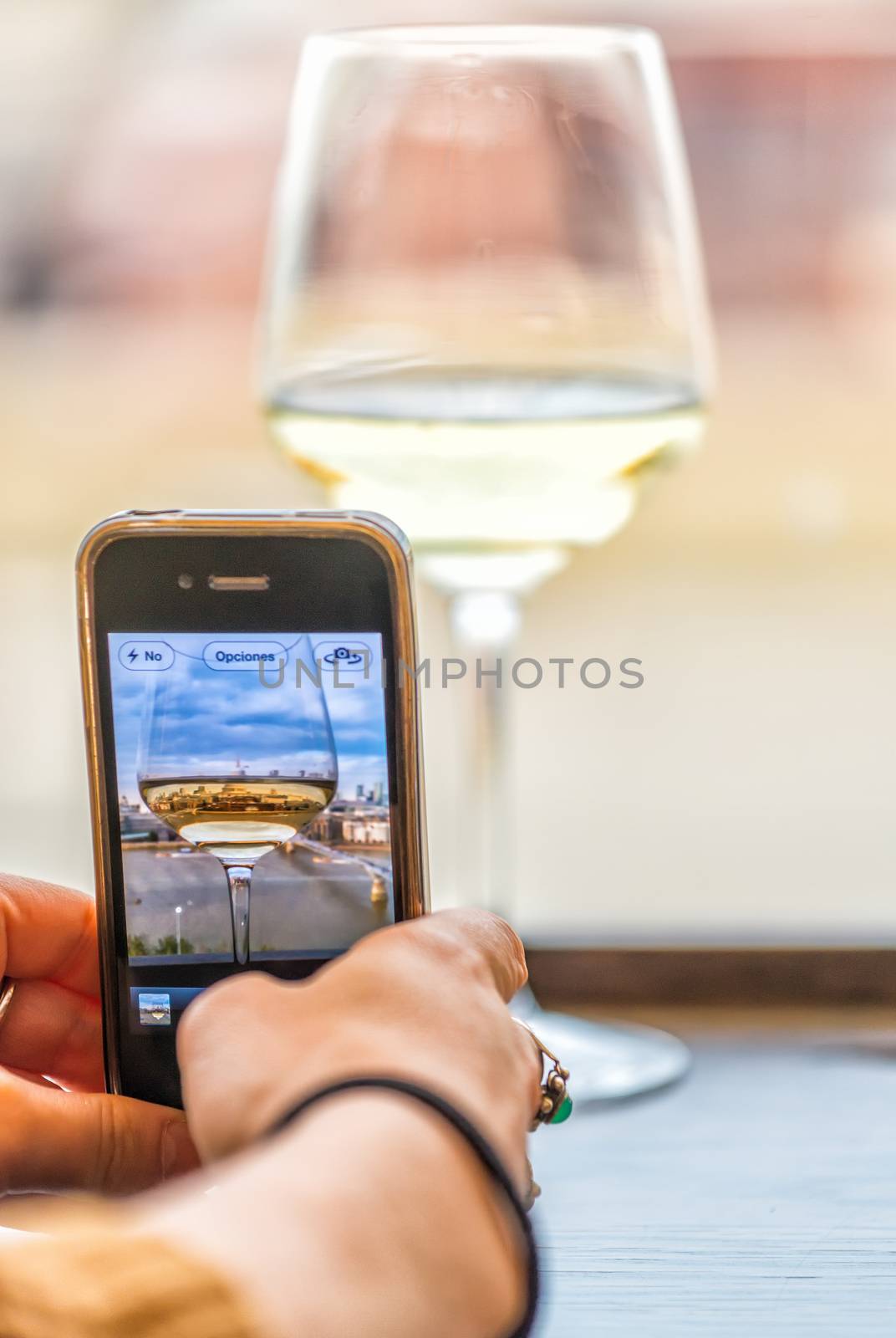 Wine glass in front of London skyline, mobile photography concept.