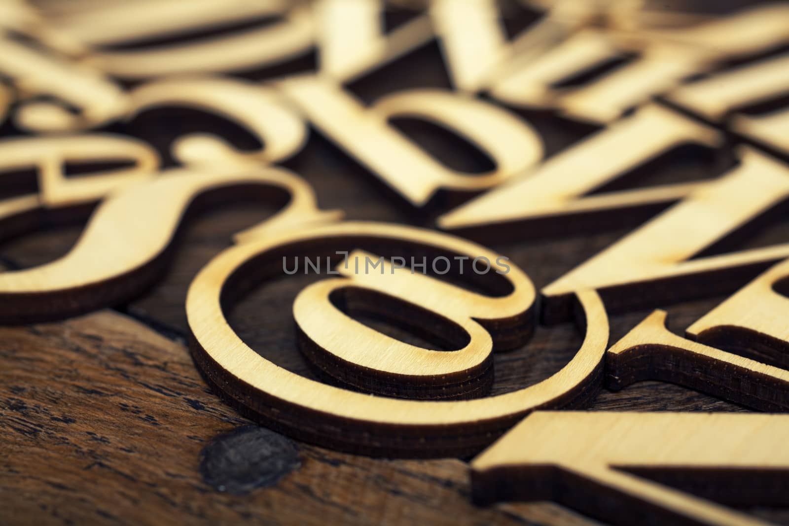 Wooden alphabet letters on old wooden surface
