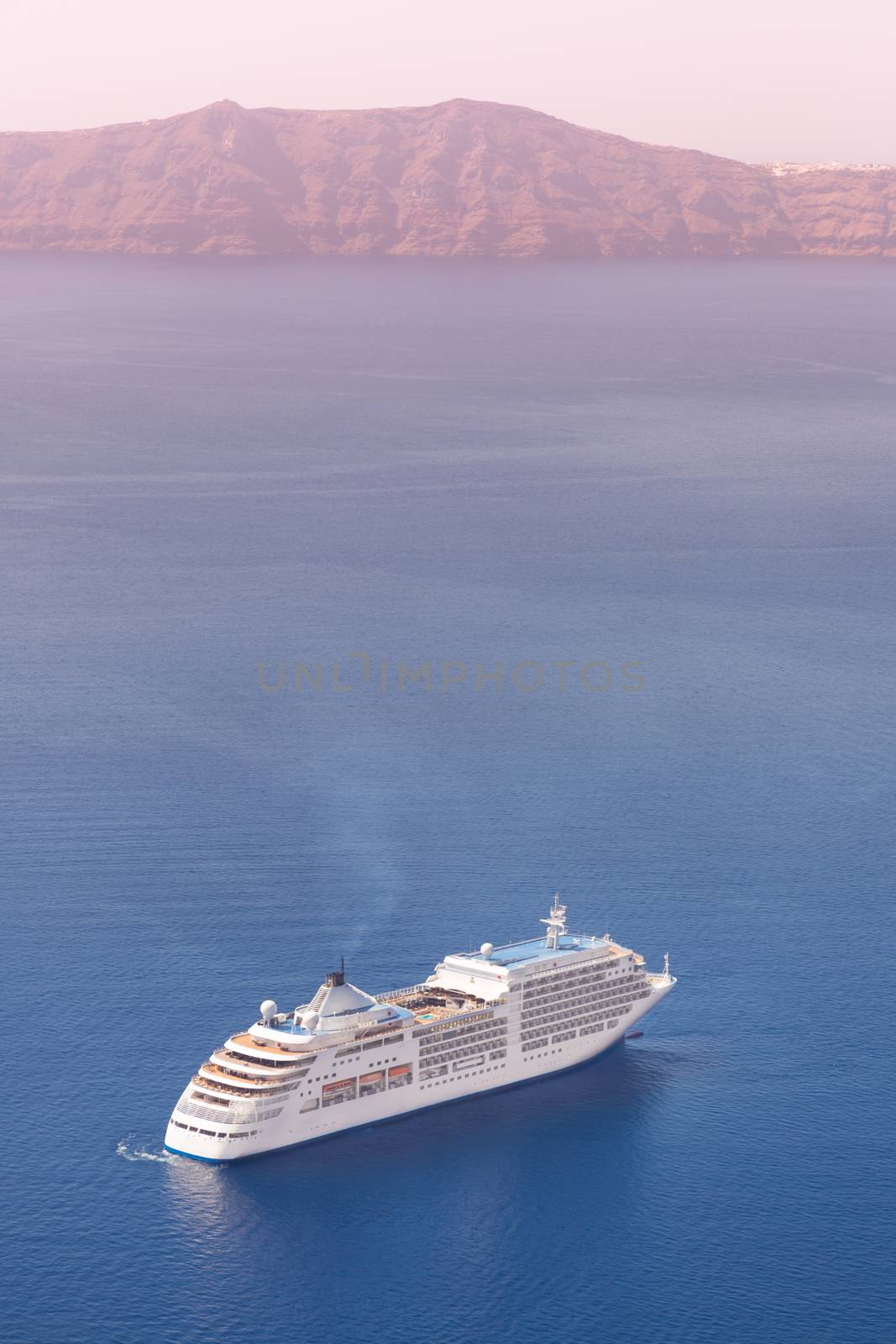 Luxury cruise ship sailing around Santorini island, Aegean sea in Greece.
