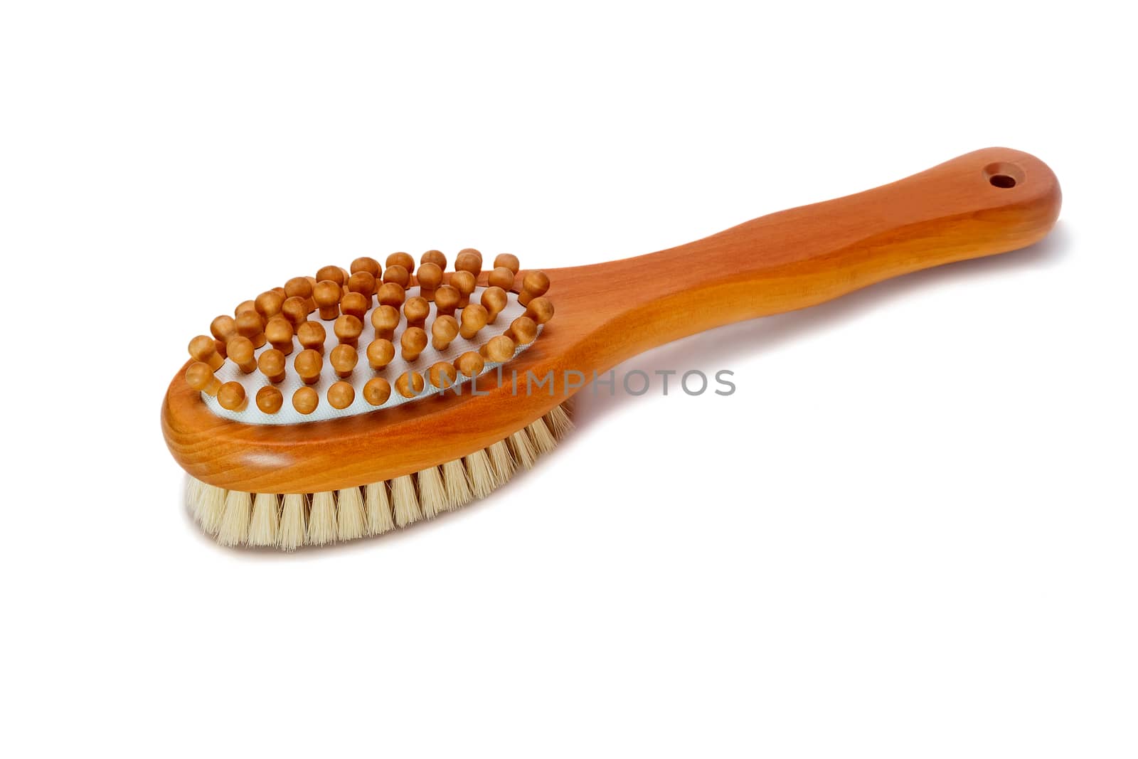 Wooden brush with wooden beads and bristles to massage the body . Presented on a white background.