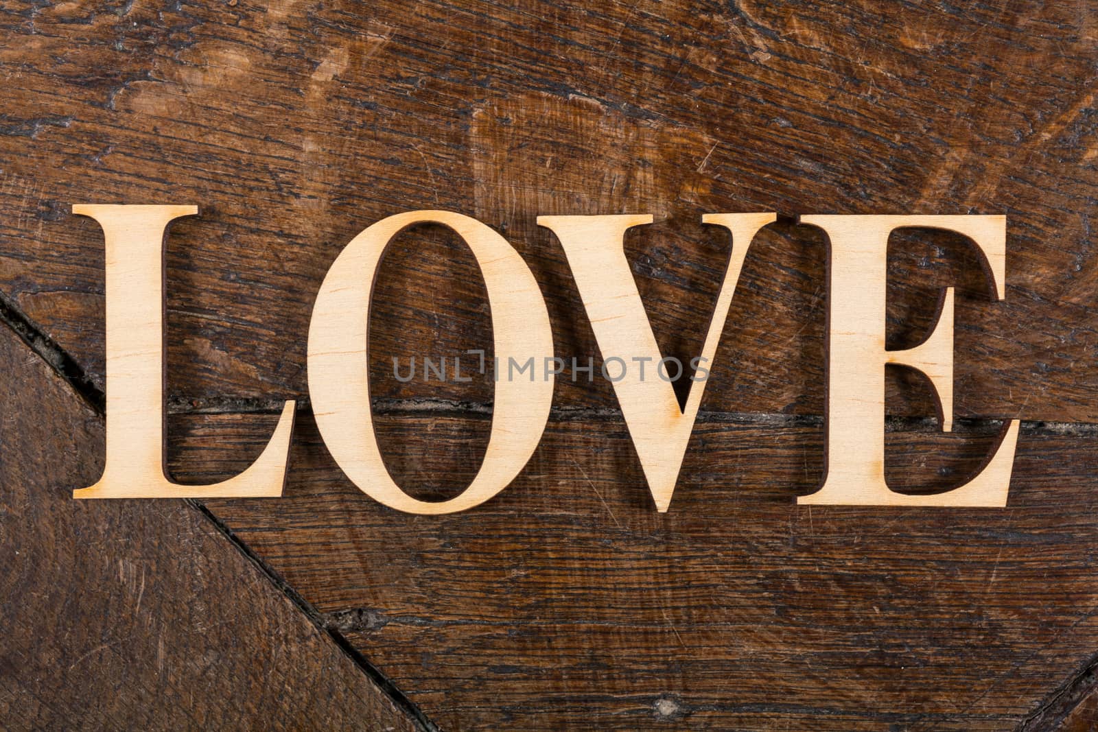 Wooden letters forming word LOVE written on old vintage wooden plates with space for your own text.