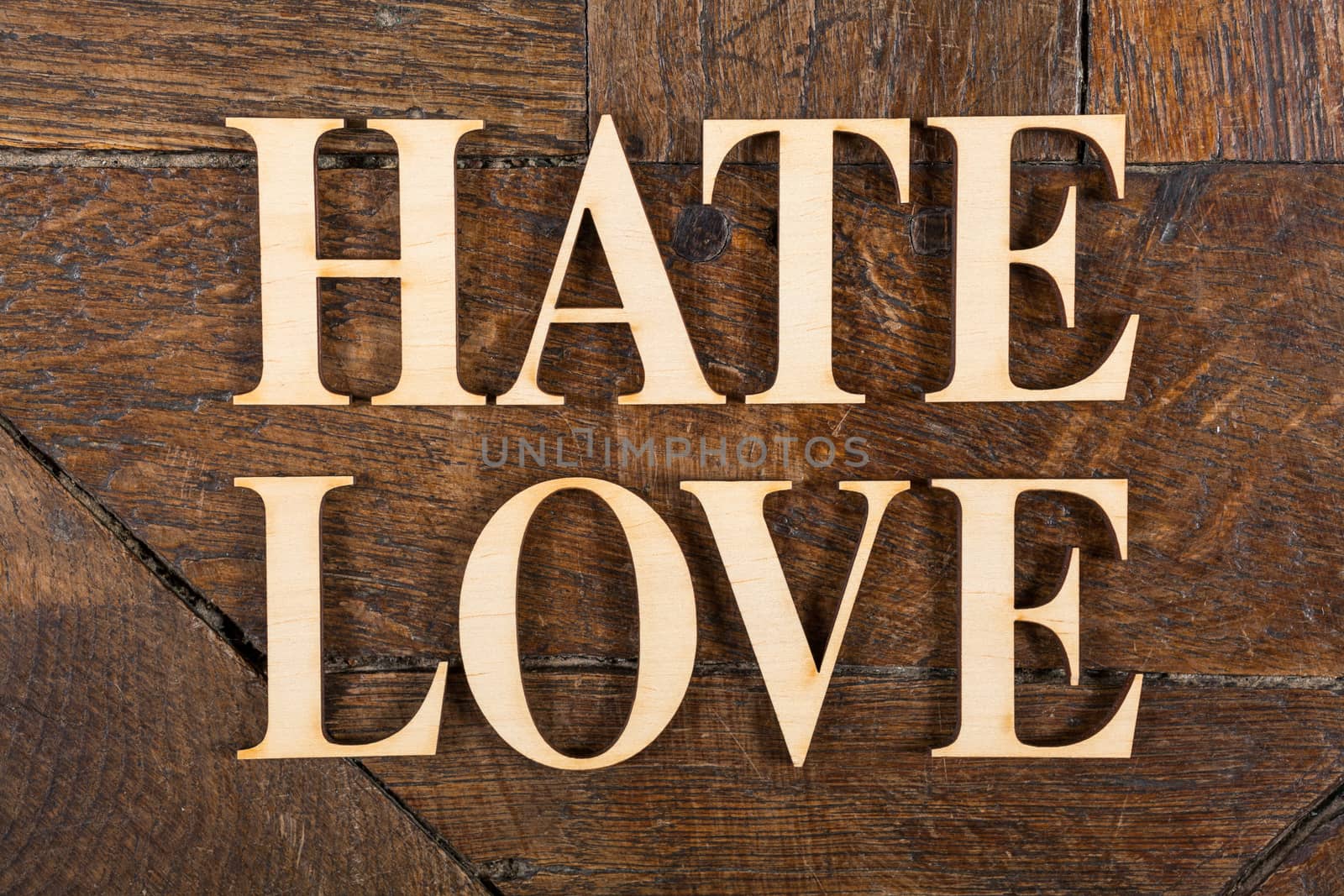 Wooden letters forming words LOVE & HATE written on old vintage wooden plates