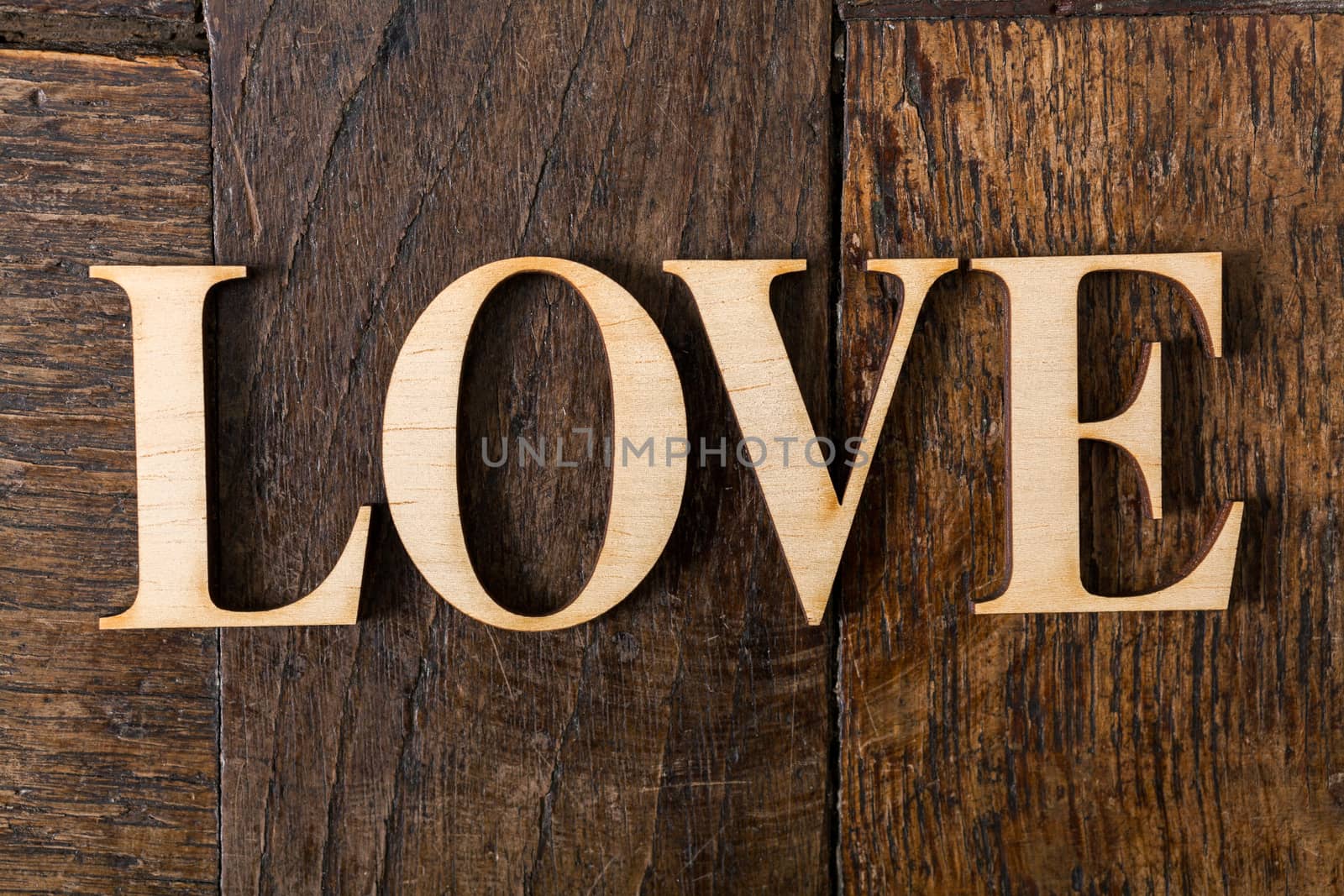 Wooden letters on wooden background by Portokalis