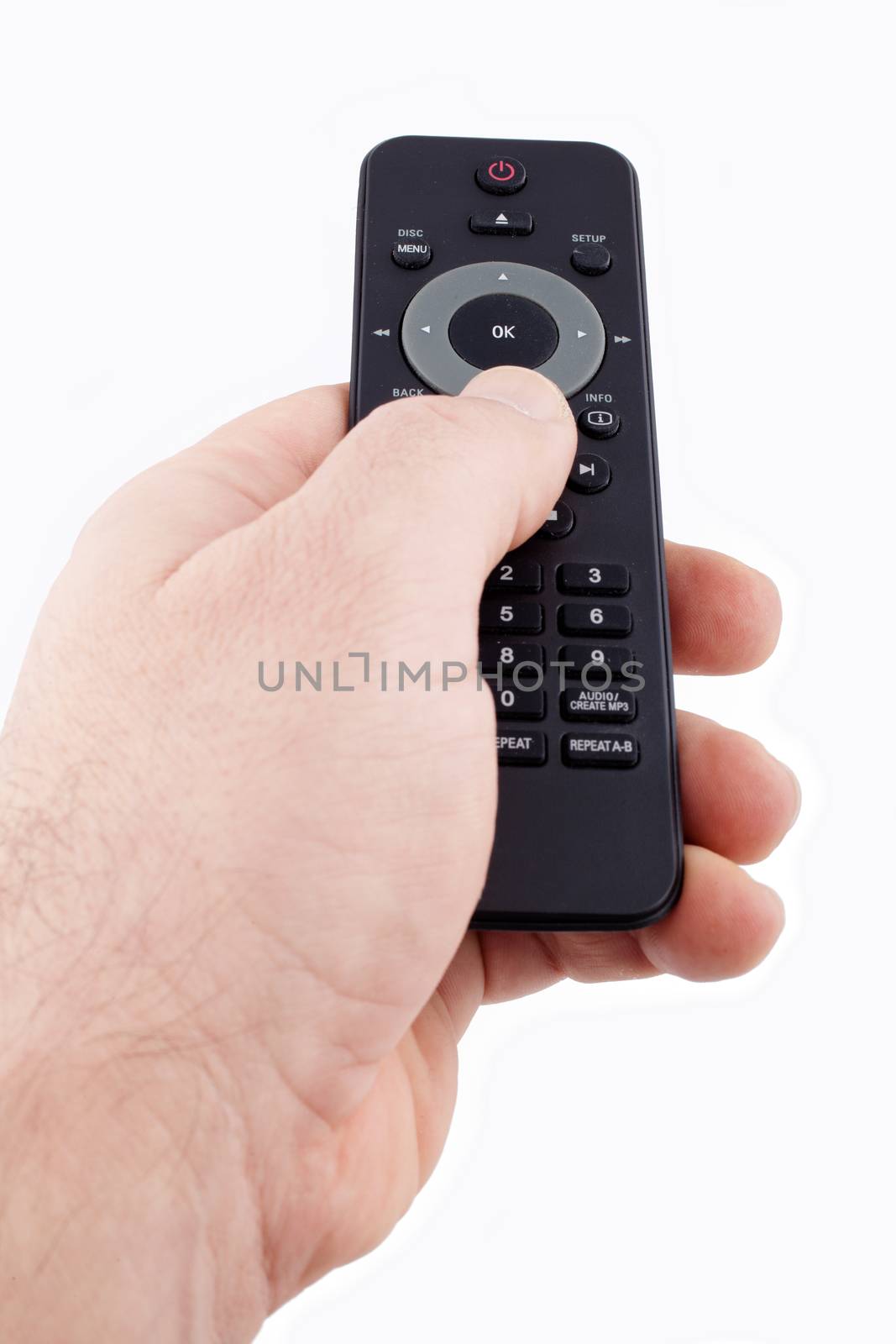Hand holding TV remote control by Portokalis