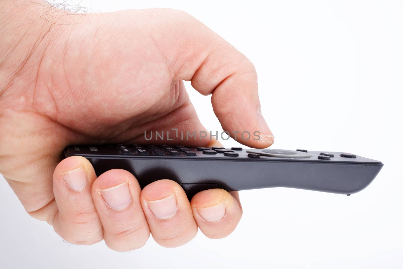 Hand holding TV remote control on white background