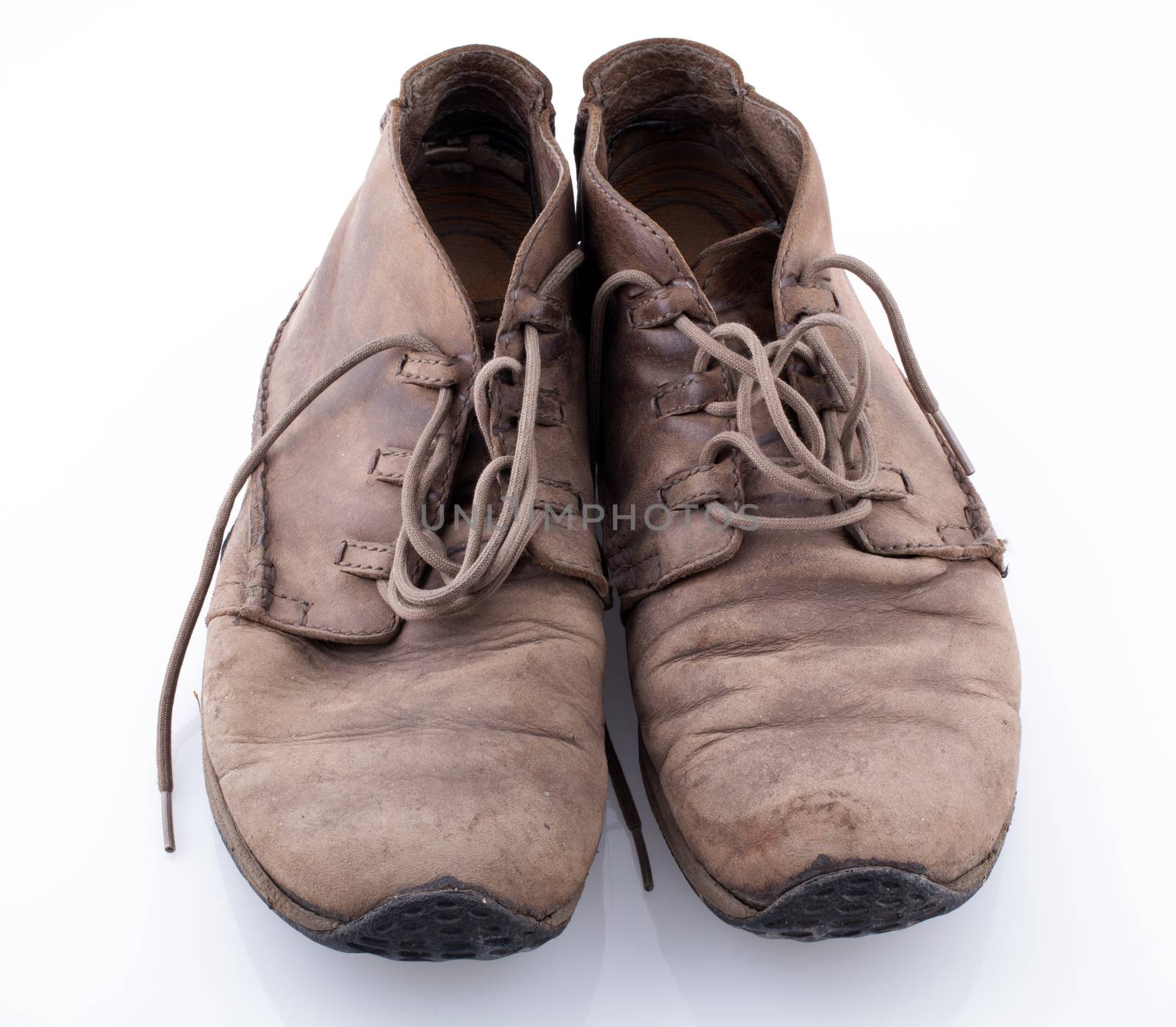 Pair of old leather boots isolated on the white background
