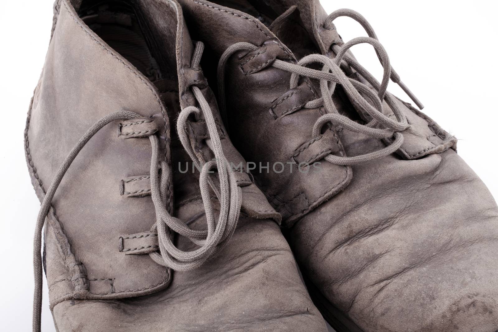 Old shoes isolated on white background by Portokalis