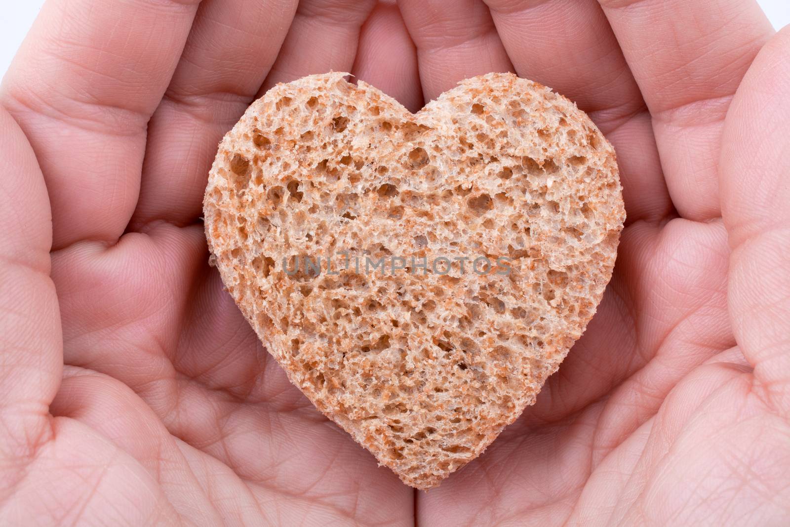 Food with love - helping the poor concept. ��ands holding a heart of bread