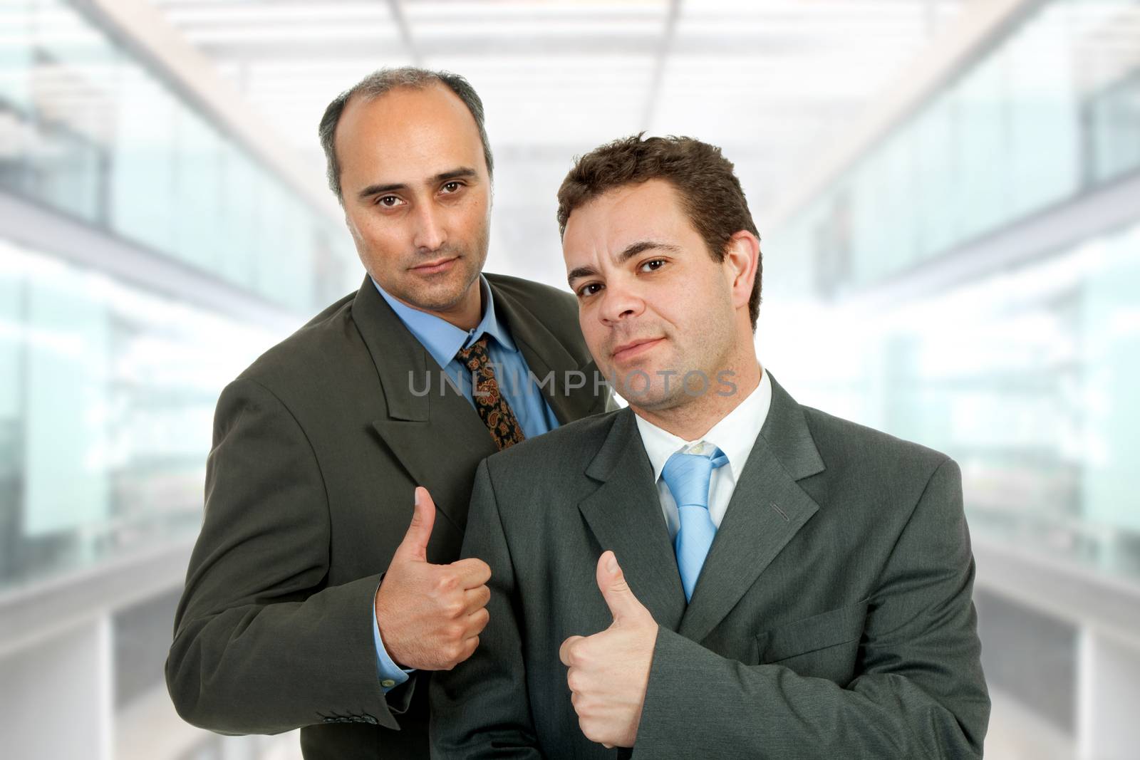 two business men going thumb up, at the office