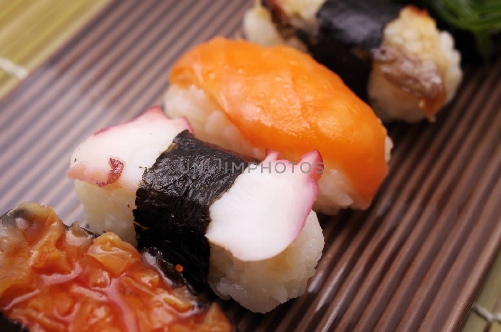 Sushi nigiri in dish with bamboo sticks  by pixbox77