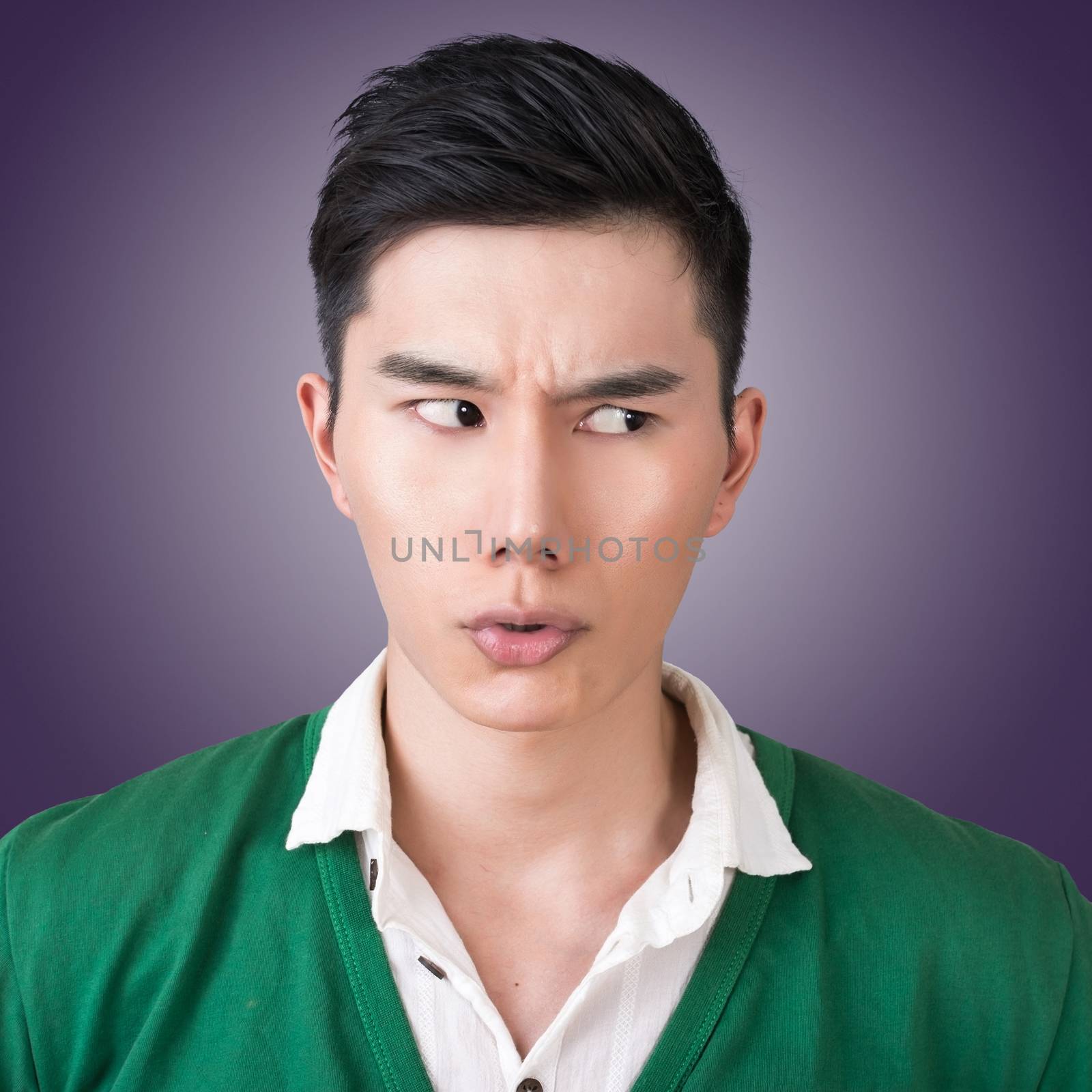 Funny facial expression, closeup Asian young man.