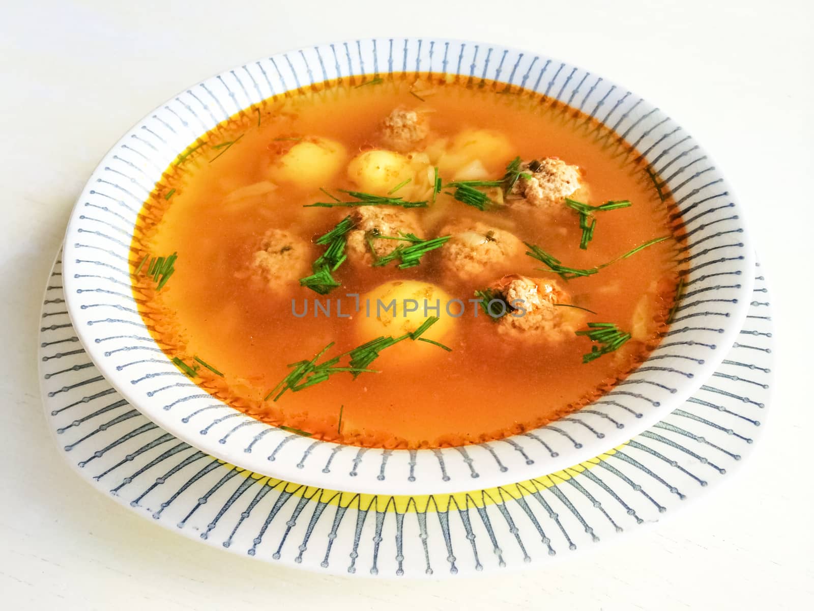 Tasty homemade soup with meatballs and potatoes.