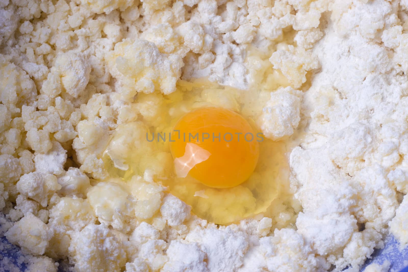 Dough with eggs and spoon in a bowl