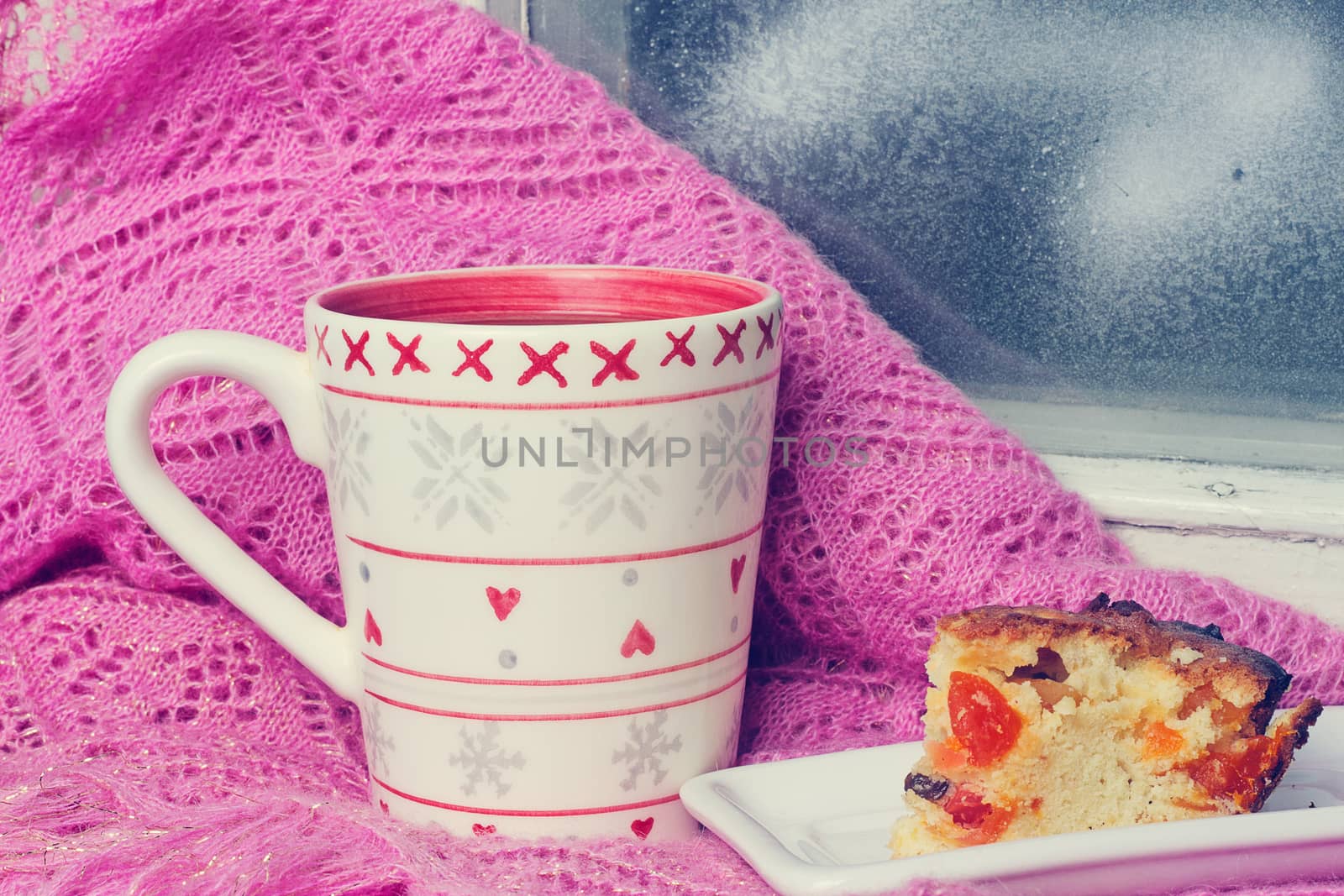 cup of tea on a windowsill near the winter window