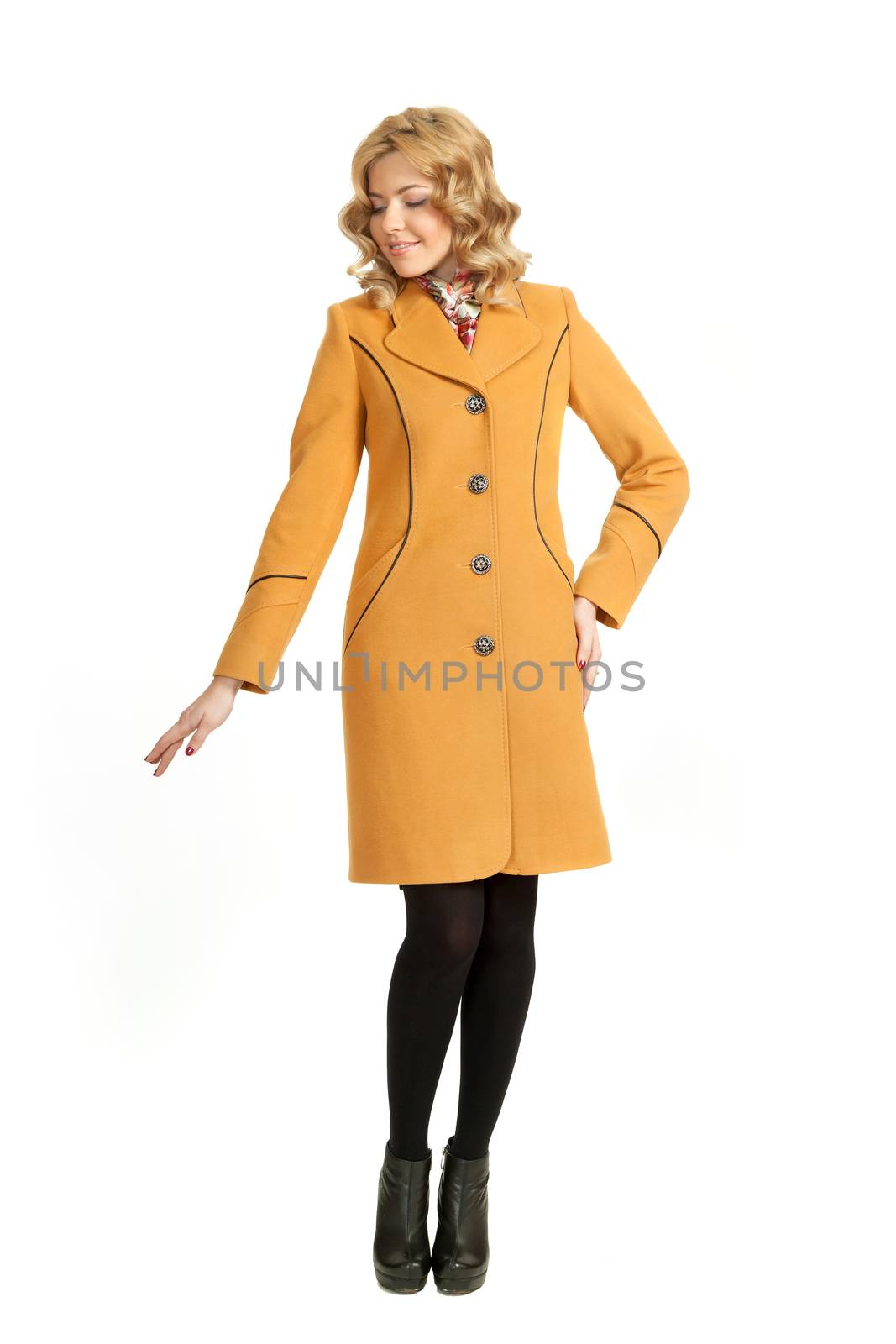 The girl in a yellow autumn coat on a white background