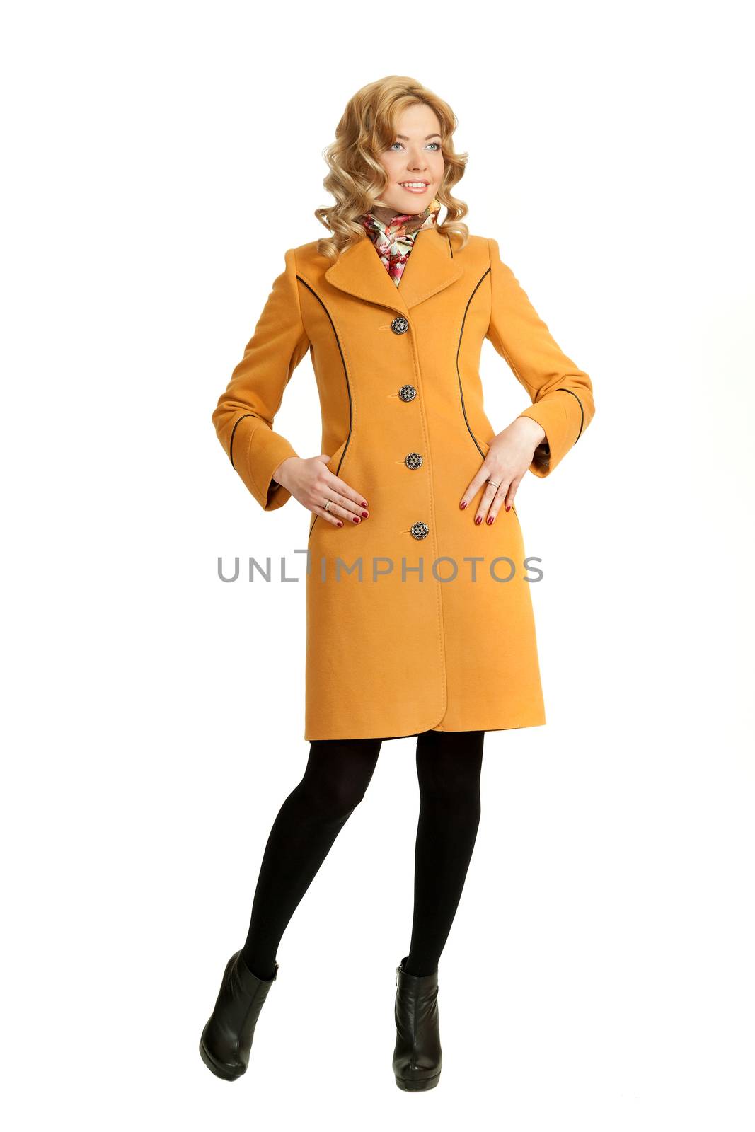 The girl in a yellow autumn coat on a white background