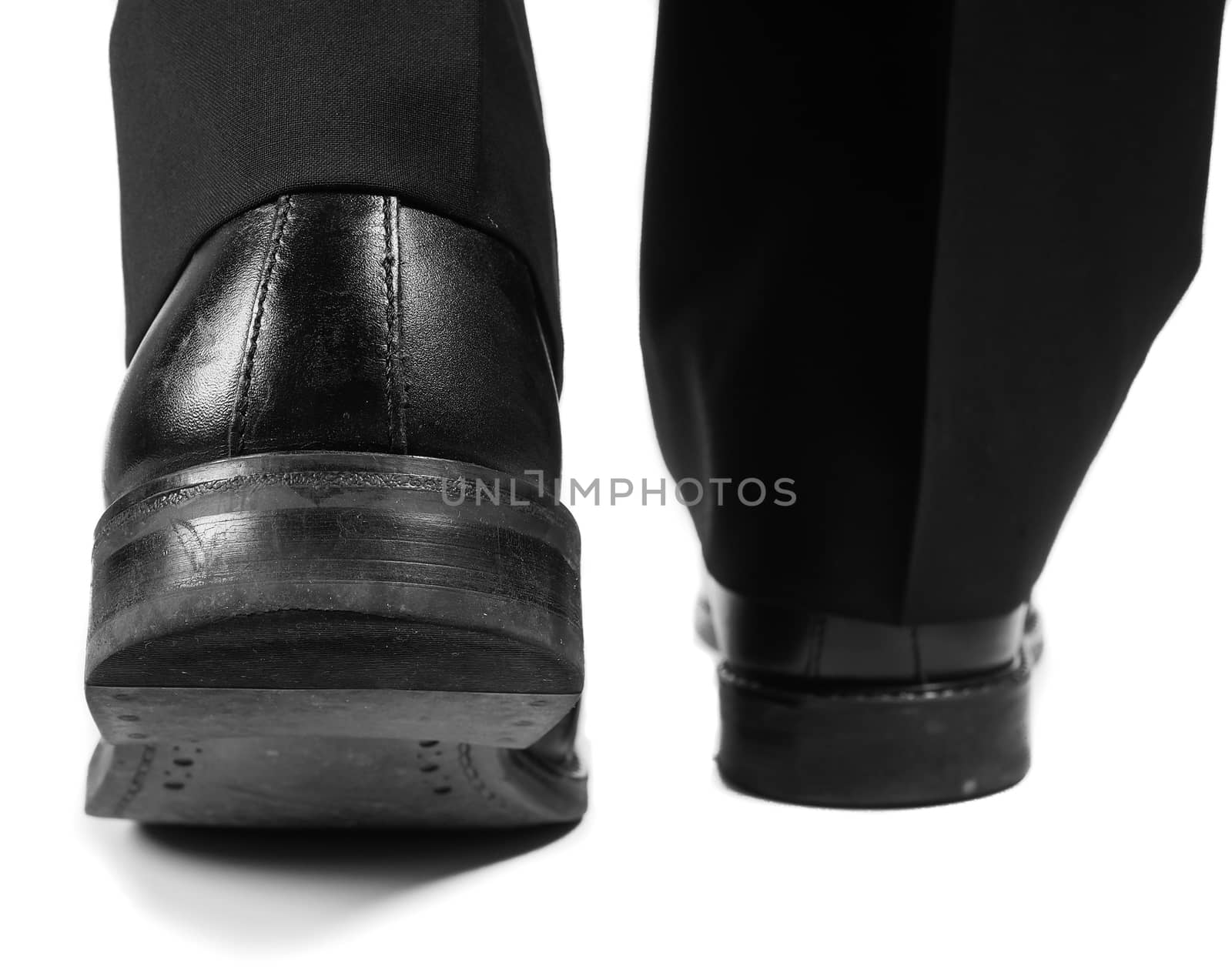 Person in black suit leaving in black shoes by Arvebettum
